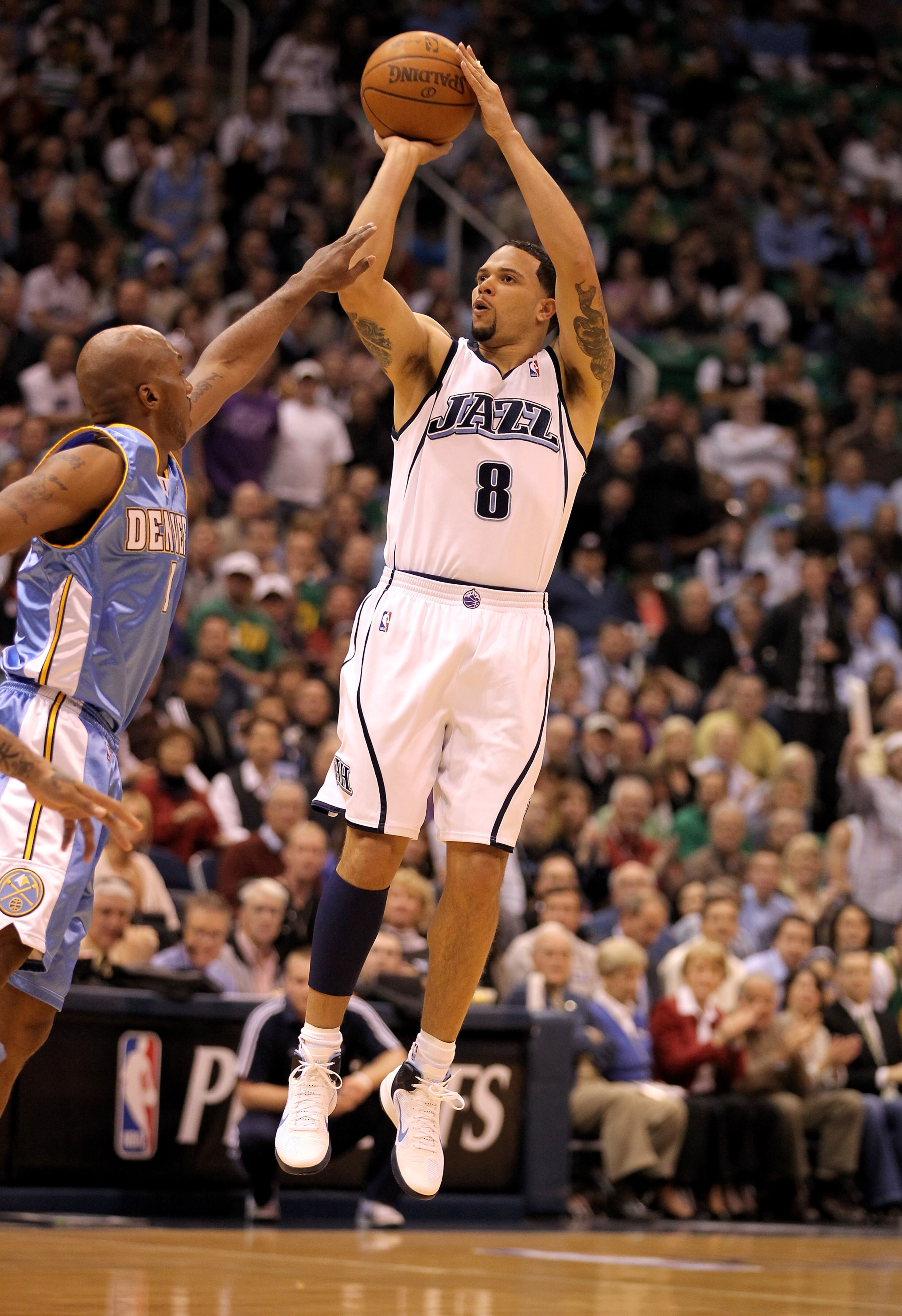 SALT LAKE CITY - APRIL 30:  Deron Williams #8 of the Utah Jazz shoots over Chauncey Billups #1 of the Denver Nuggets during Game Six of the Western Conference Quarterfinals of the 2010 NBA Playoffs at EnergySolutions Arena on April 30, 2010 in Salt Lake C