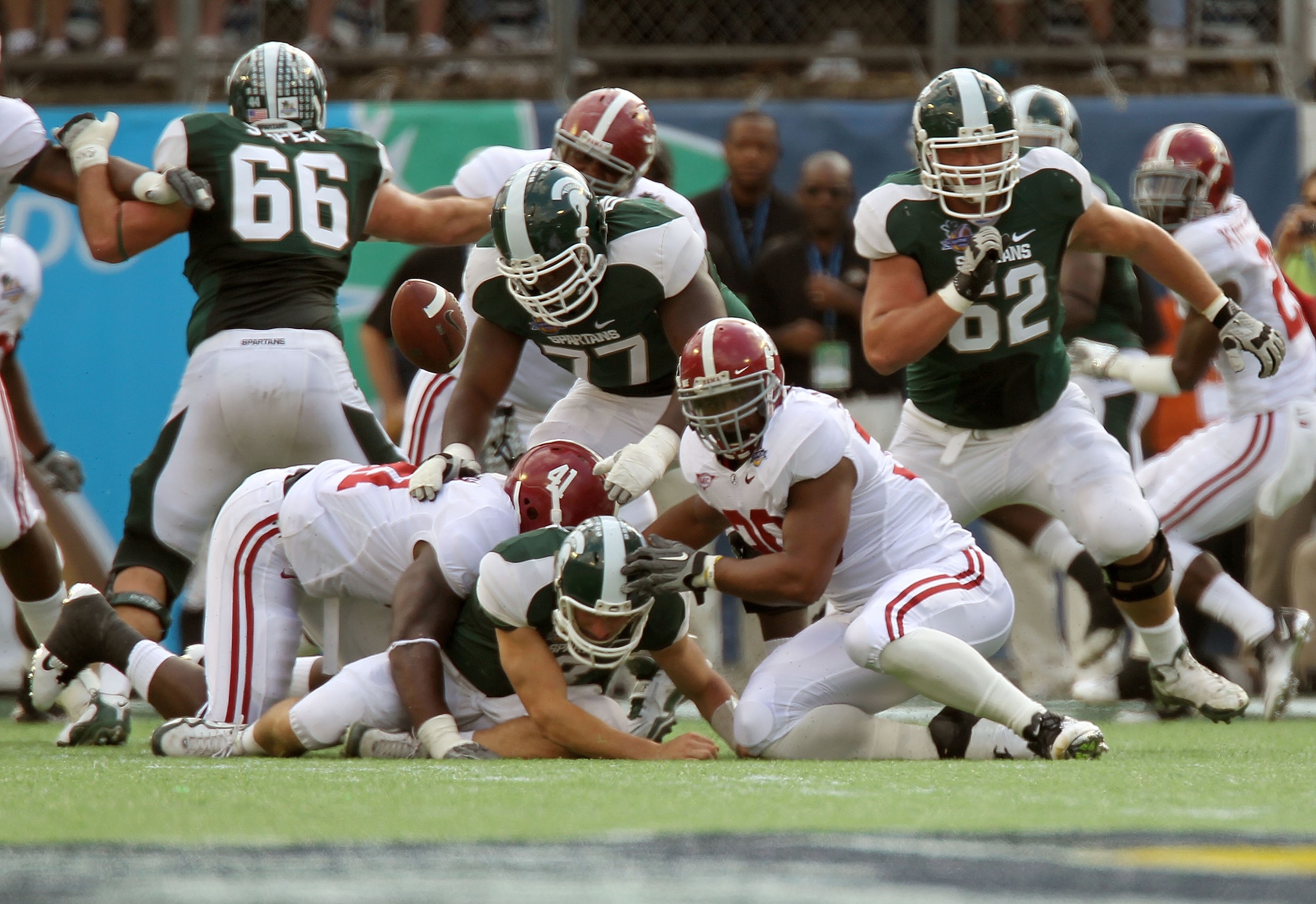 ORLANDO, FL - JANUARY 01:  Kirk Cousins #8  of the Michigan State Spartans is sacked by Courtney Upshaw #41 of the Alabama Crimson Tide during the Capitol One Bowl at the Florida Citrus Bowl on January 1, 2011 in Orlando, Florida.  (Photo by Mike Ehrmann/