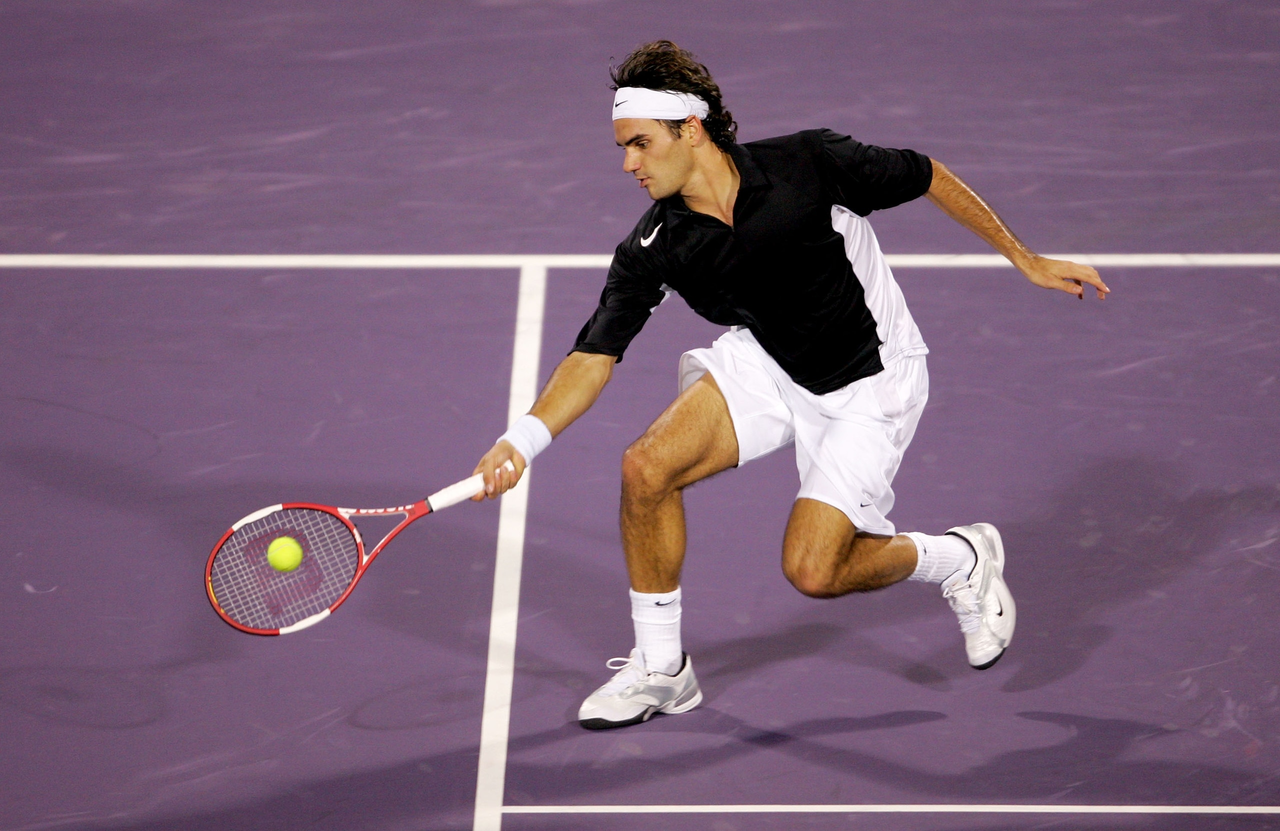 HOUSTON - NOVEMBER 17:  Roger Federer of Switzerland returns to Lleyton Hewitt of Australia during the round robin stage of the Tennis Masters Cup November 17, 2004 at the Westside Tennis Club in Houston, Texas.  (Photo by Matthew Stockman/Getty Images)