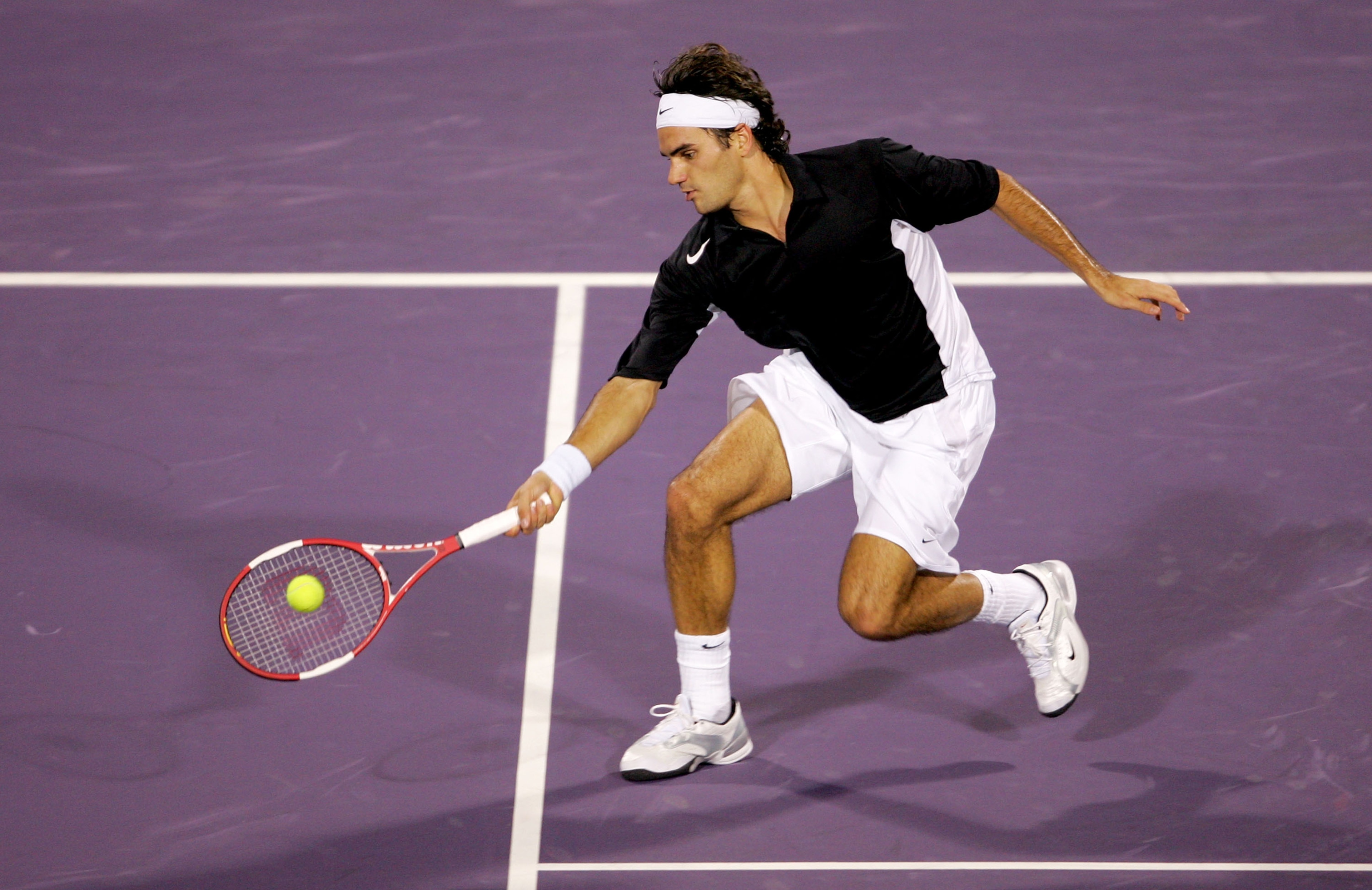 HOUSTON - NOVEMBER 17:  Roger Federer of Switzerland returns to Lleyton Hewitt of Australia during the round robin stage of the Tennis Masters Cup November 17, 2004 at the Westside Tennis Club in Houston, Texas.  (Photo by Matthew Stockman/Getty Images)
