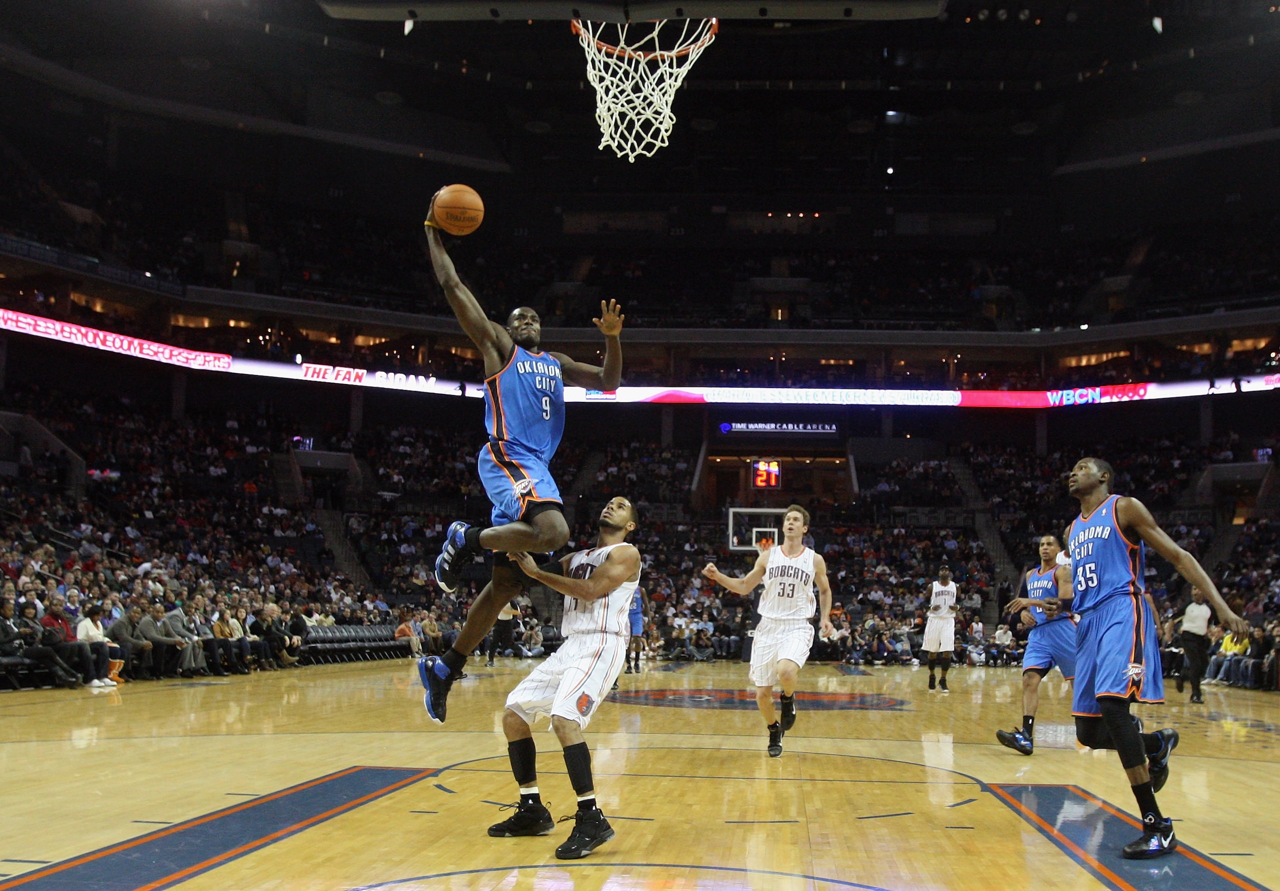 CHARLOTTE, NC - DECEMBER 21:  Serge Ibaka #9 of the Oklahoma Thunder is fouled by D.J. Augustin #14 of the Charlotte Bobcats during their game at Time Warner Cable Arena on December 21, 2010 in Charlotte, North Carolina. NOTE TO USER: User expressly ackno