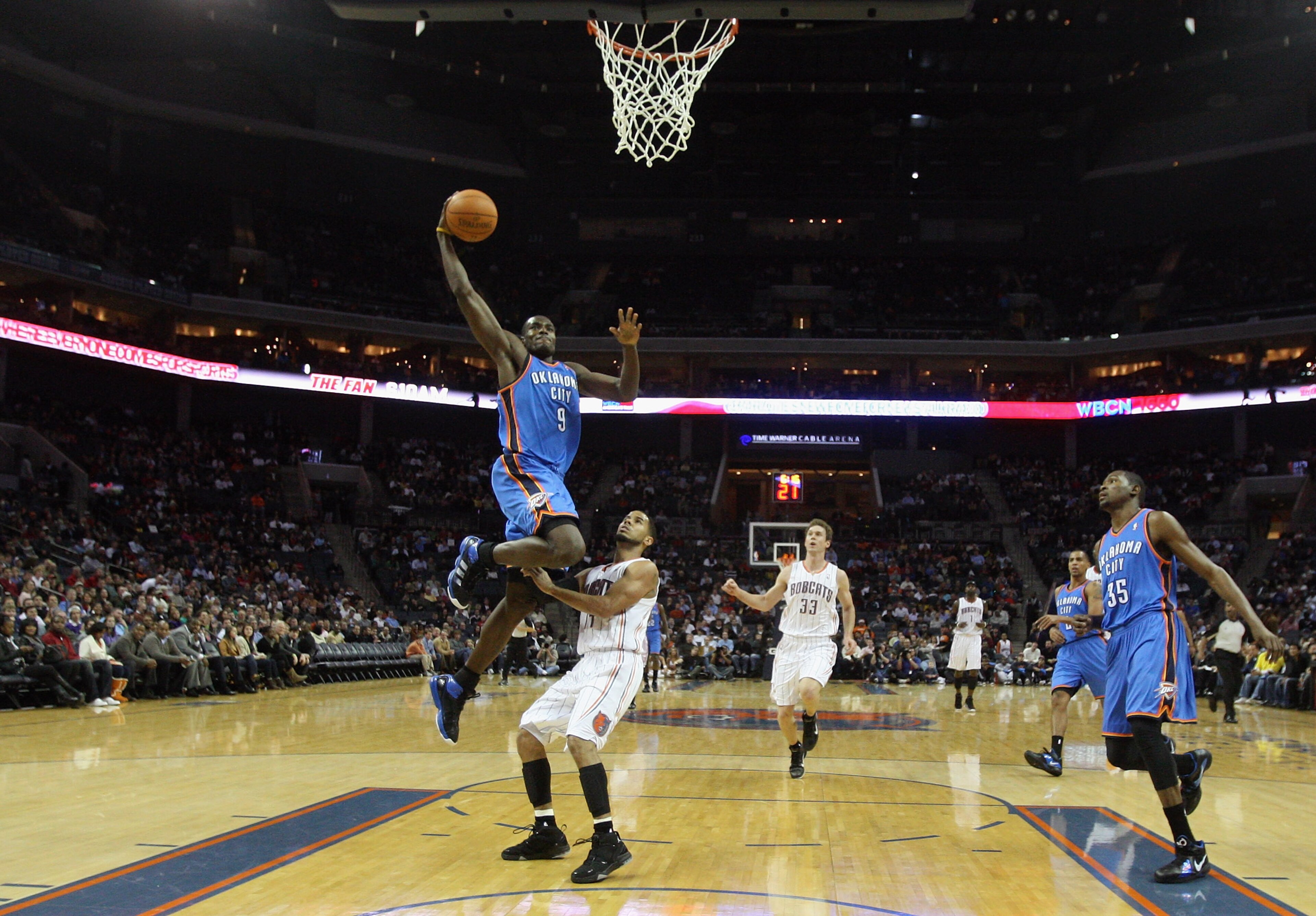 CHARLOTTE, NC - DECEMBER 21:  Serge Ibaka #9 of the Oklahoma Thunder is fouled by D.J. Augustin #14 of the Charlotte Bobcats during their game at Time Warner Cable Arena on December 21, 2010 in Charlotte, North Carolina. NOTE TO USER: User expressly ackno