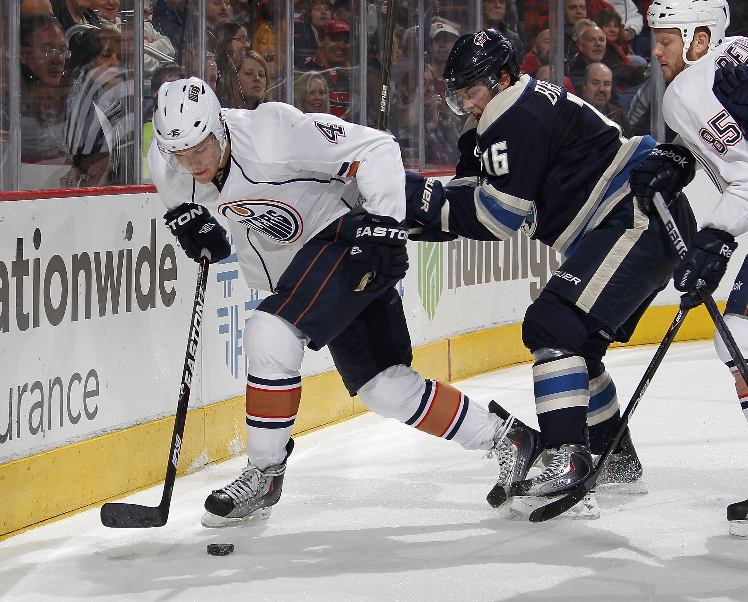 COLUMBUS, OH - FEBRUARY 05:  Taylor Hall #4 of the Edmonton Oilers tries to control the puck in front of Derick Brassard #16 of the Columbus Blue Jackets at Nationwide Arena on February 5, 2011 in Columbus, Ohio.  (Photo by Gregory Shamus/Getty Images)