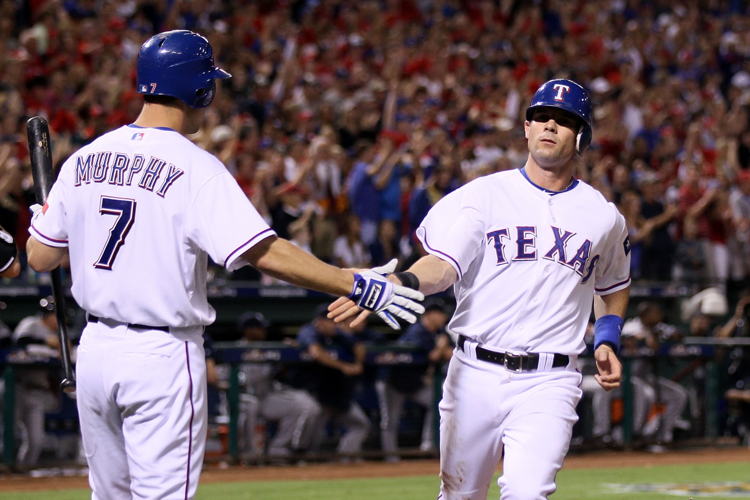 ARLINGTON, TX - OCTOBER 22: Michael Young #10 of the Texas Rangers celebrates with David Murphy #7 after Young scored on a sacrifice fly by Ian Kinsler #5 in the bottom of the seventh inning against the New York Yankees in Game Six of the ALCS during the ARLINGTON, TX - OCTOBER 22: Michael Young #10 of the Texas Rangers celebrates with David Murphy #7 after Young scored on a sacrifice fly by Ian Kinsler #5 in the bottom of the seventh inning against the New York Yankees in Game Six of the ALCS during the