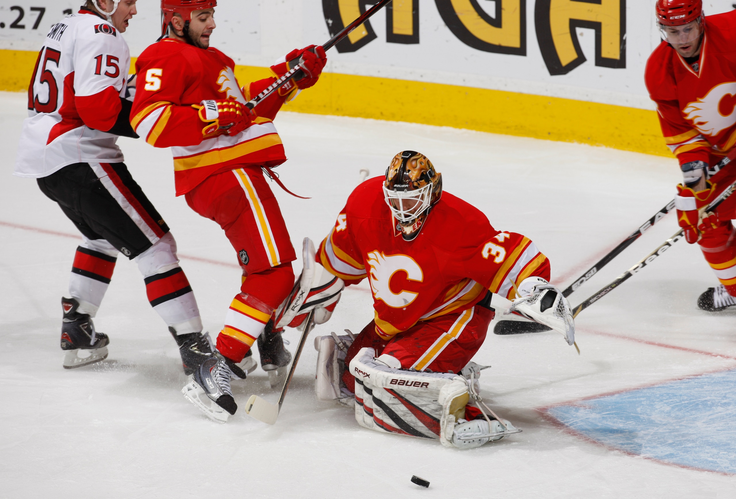 CALGARY, CANADA - FEBRUARY 9: Miikka Kiprusoff #34 of the Calgary Flames makes a save on Zack Smith #15 of the Ottawa Senators in first period action at Scotiabank Saddledome February 9, 2011 in Calgary, Alberta, Canada. (Photo by Dale MacMillan/Getty Ima