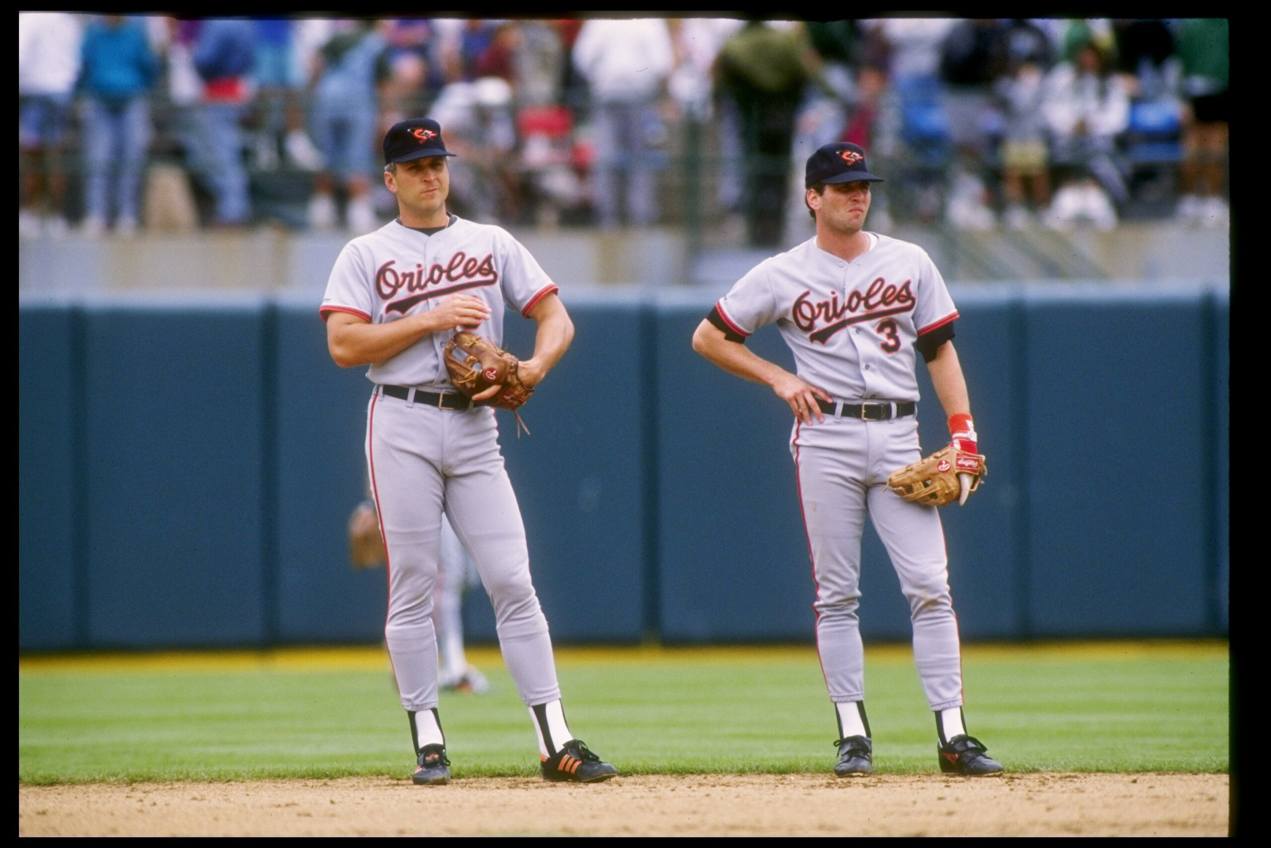 24 Jul 1991: Shortstop Cal Ripken Jr. of the Baltimore Orioles (left) stands with teammate and brother second baseman Billy Ripken during a game against the Oakland Athletics.
