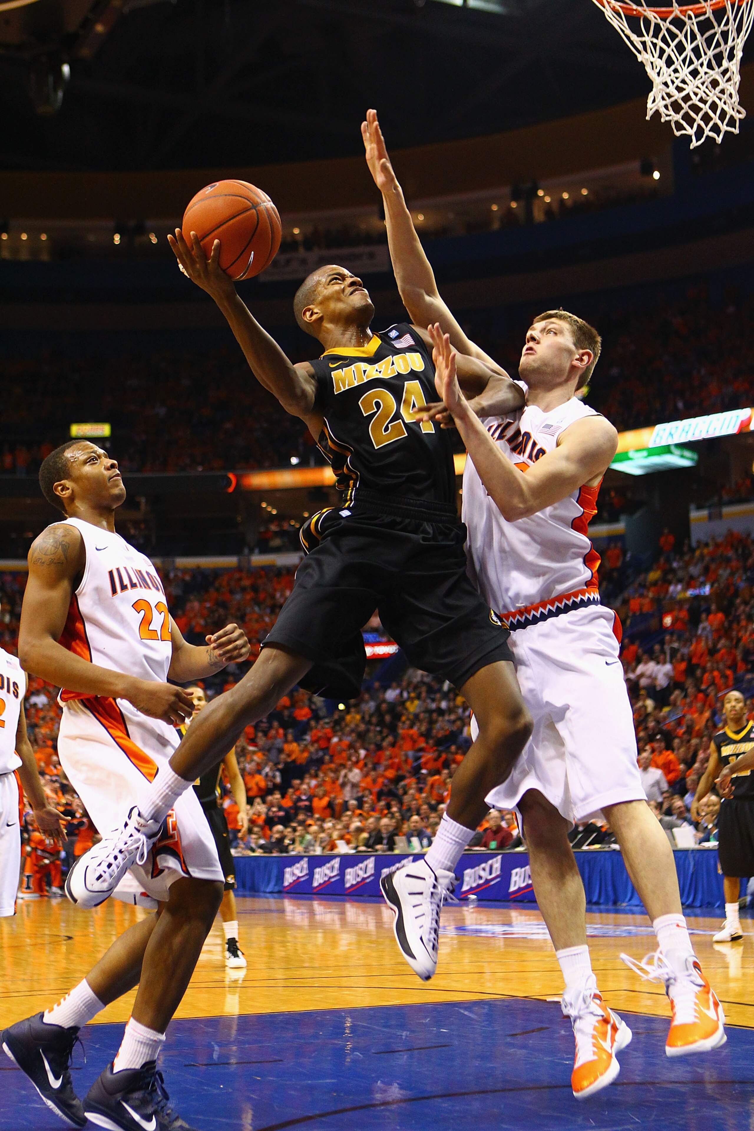 ST. LOUIS, MO - DECEMBER 22: Kim English #24 of the Missouri Tigers looks to shoot the ball against Tyler Griffey #42 of the Illinois Fighting Illini during the Busch Braggin' Rights game at the Scottrade Center on December 22, 2010 in St. Louis, Missouri