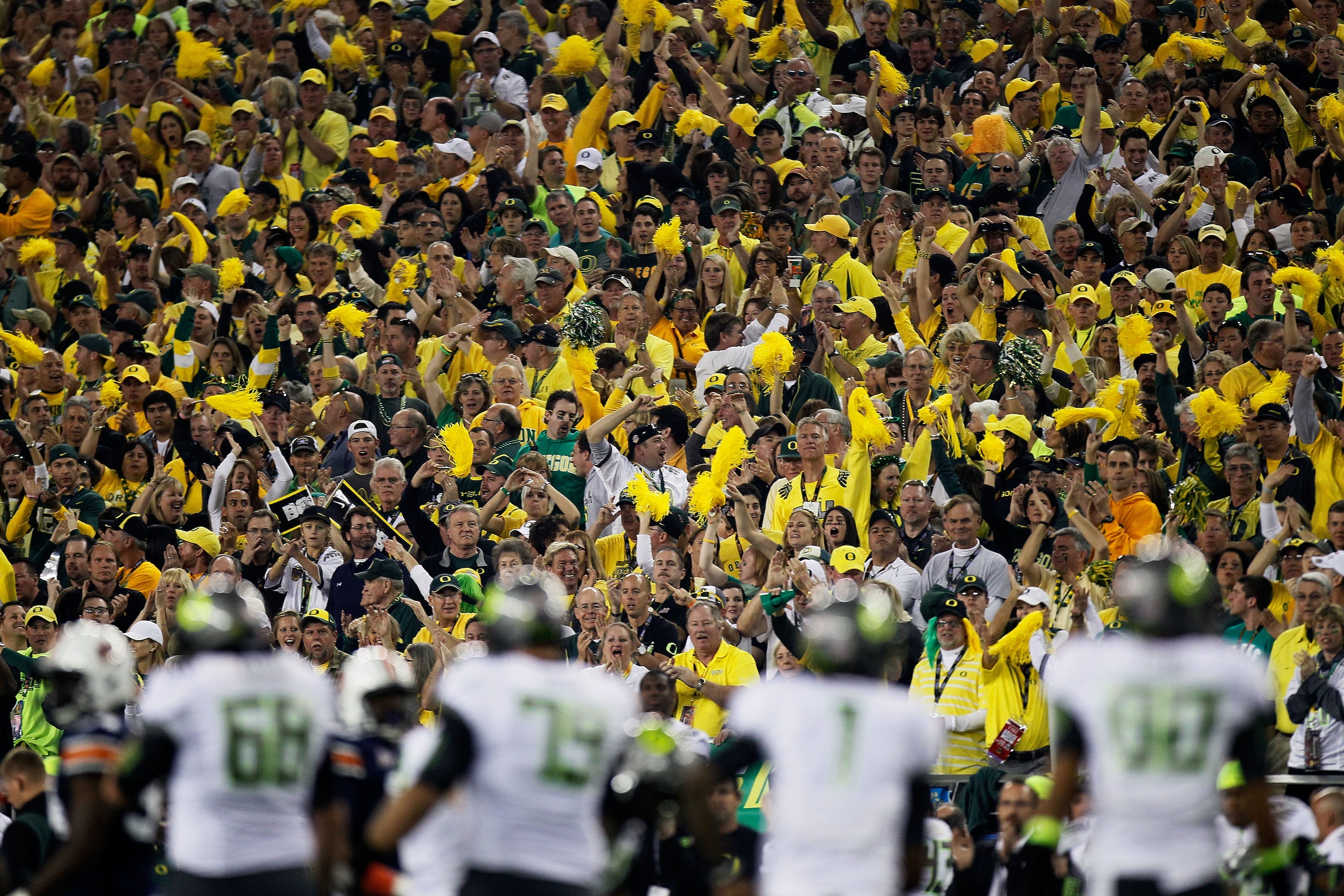 GLENDALE, AZ - JANUARY 10:  The Oregon Ducks fans cheer as the Ducks offense is on the field against the Auburn Tigers defense during the Tostitos BCS National Championship Game at University of Phoenix Stadium on January 10, 2011 in Glendale, Arizona.  (
