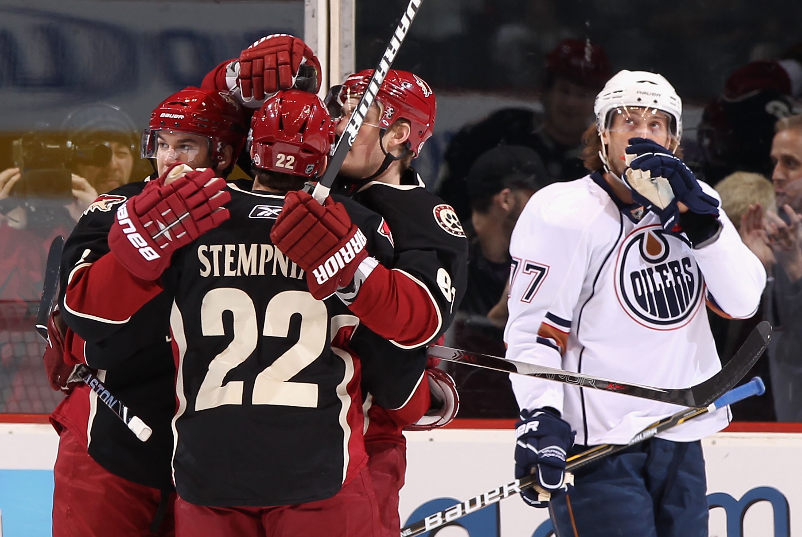 GLENDALE, AZ - JANUARY 25:  (L-R) Scottie Upshall #8, Lee Stempniak #22 and Kyle Turris #91 of the Phoenix Coyotes celebrate after Upshall scored a first period power play goal against the Edmonton Oilers during the NHL game at Jobing.com Arena on January