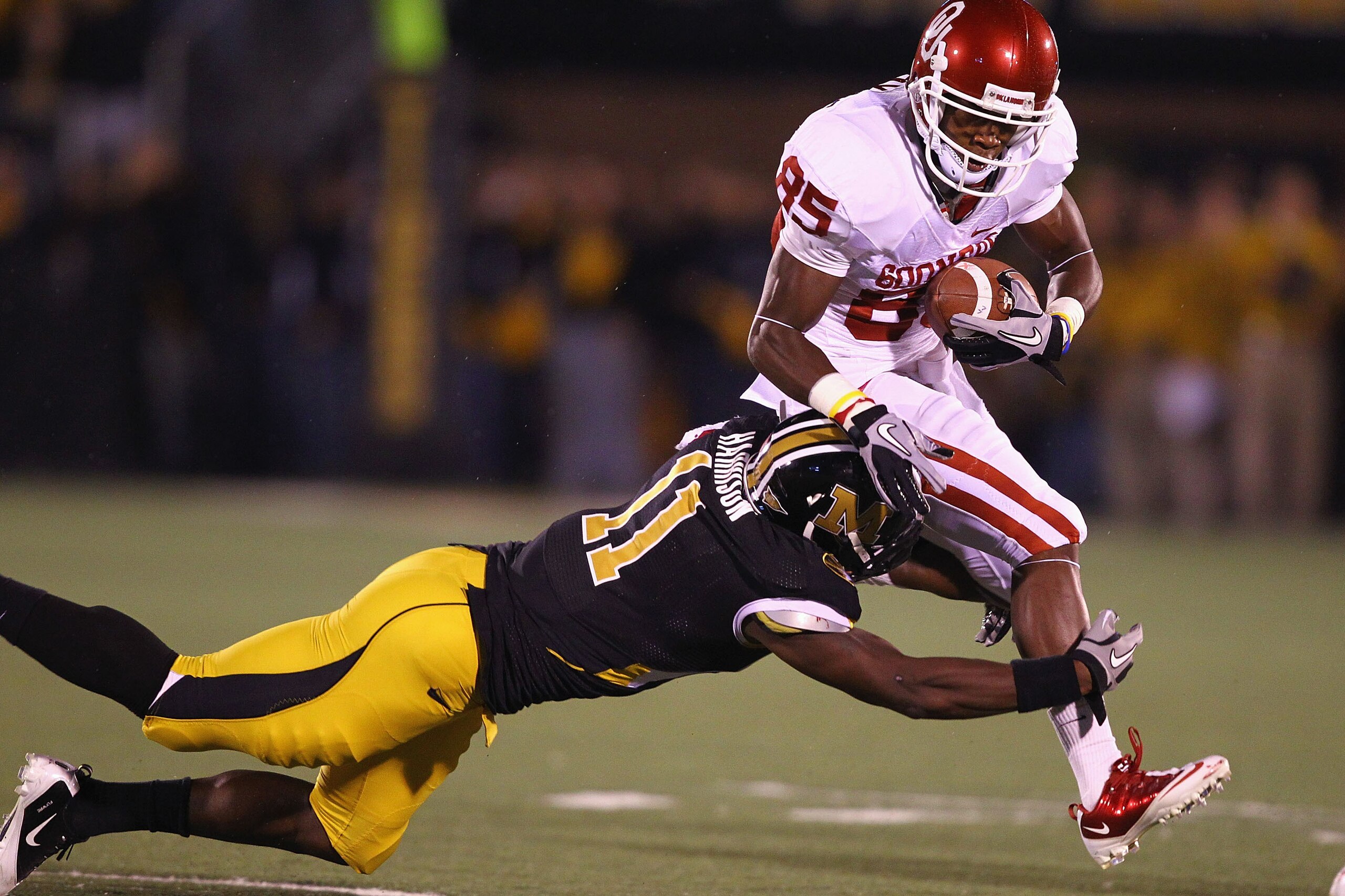 COLUMBIA, MO - OCTOBER 23: Ryan Broyles #85 of the Oklahoma Sooners is tackled by Jarrell Harrison #11 of the Missouri Tigers at Faurot Field/Memorial Stadium on October 23, 2010 in Columbia, Missouri.  (Photo by Dilip Vishwanat/Getty Images)