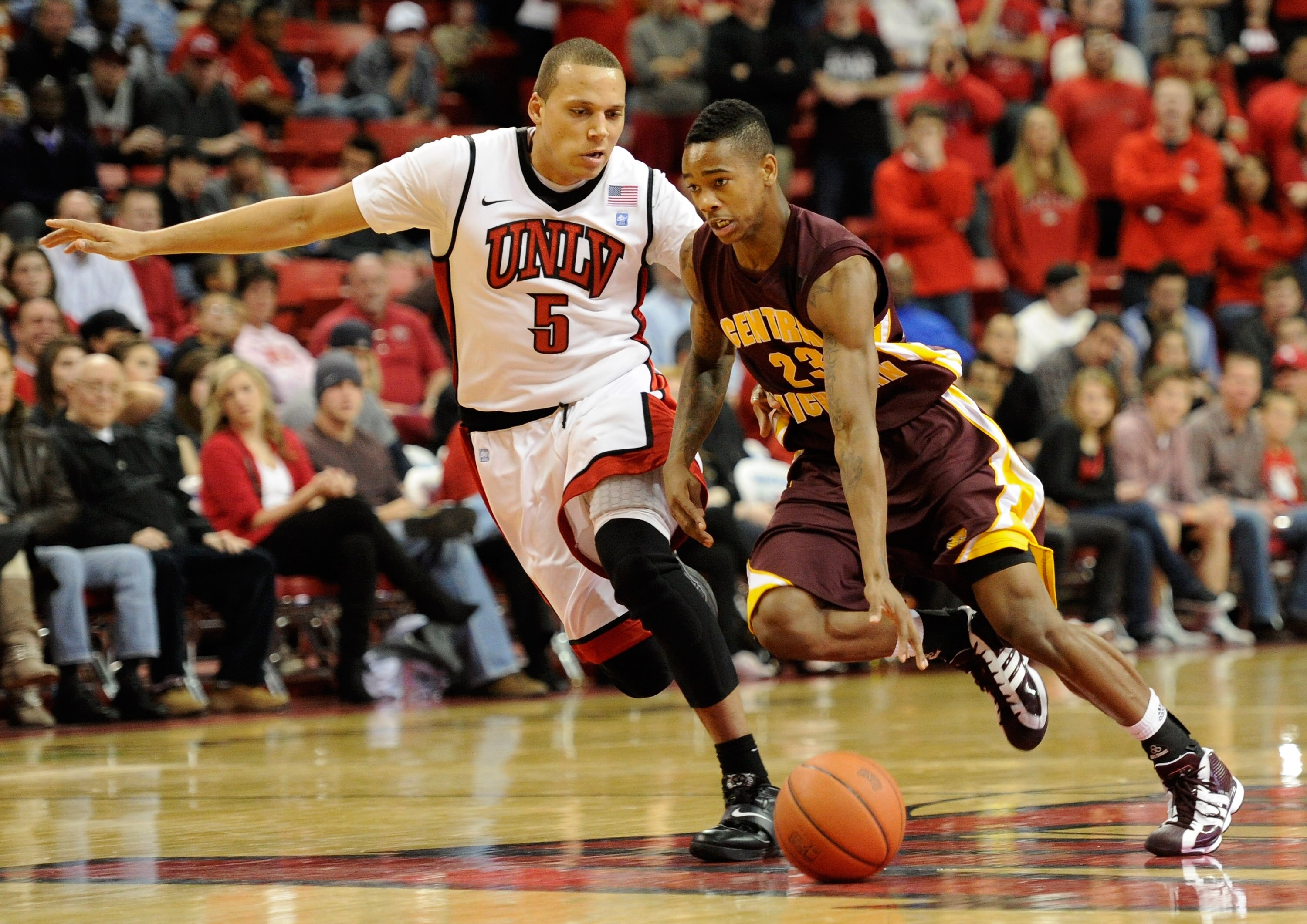 LAS VEGAS, NV - DECEMBER 30:  Derek Jackson #23 of the Central Michigan Chippewas brings the ball up the court against Derrick Jasper #5 of the UNLV Rebels during their game at the Thomas & Mack Center December 30, 2010 in Las Vegas, Nevada. UNLV won 73-4