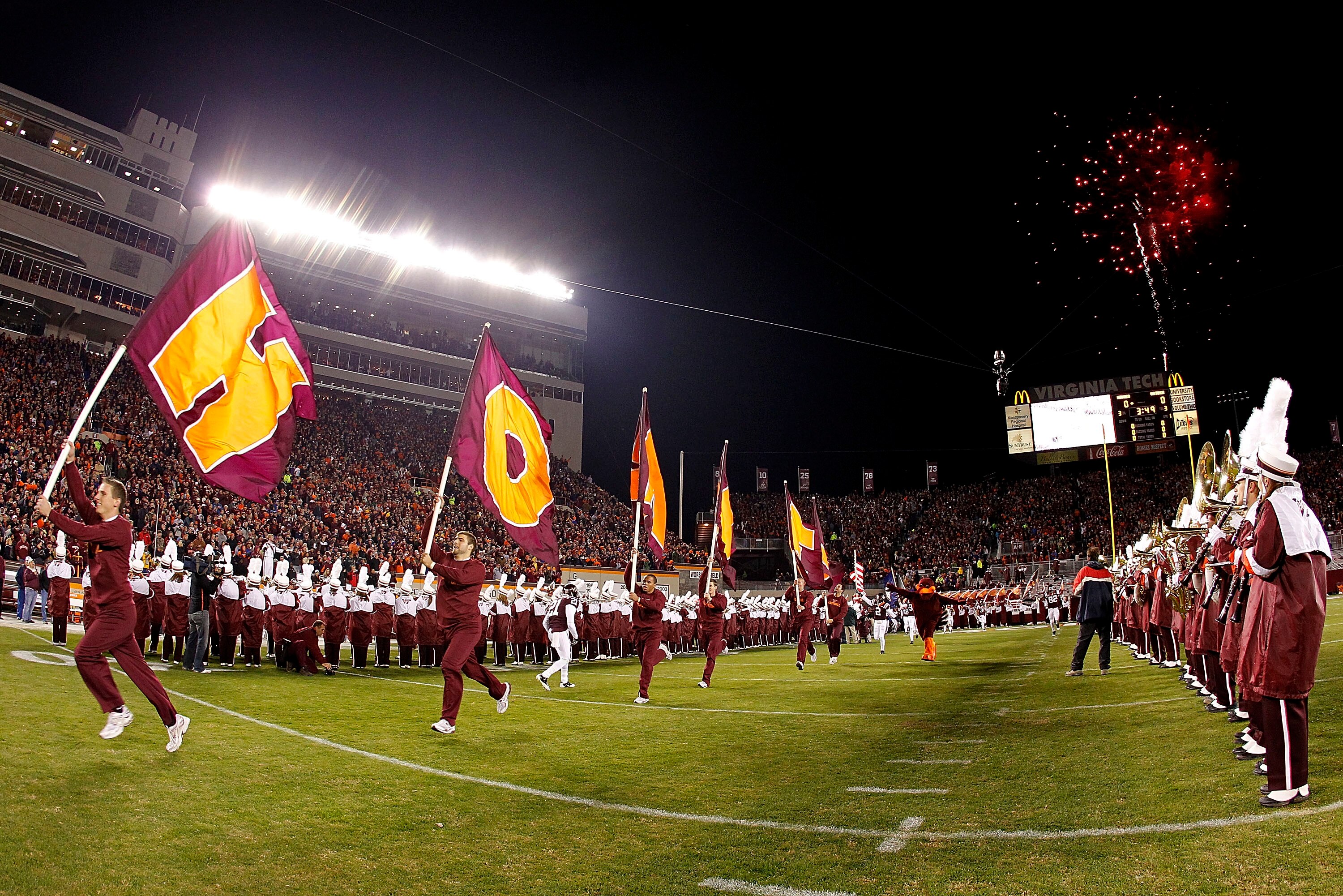 BLACKSBURG, VA - NOVEMBER 04: Cheerleaders from the Virginia Tech Hokies lead the players onto the field prior to the Hokies game against the Georgia Tech Yellow Jackets at Lane Stadium on November 4, 2010 in Blacksburg, Virginia.  (Photo by Geoff Burke/G