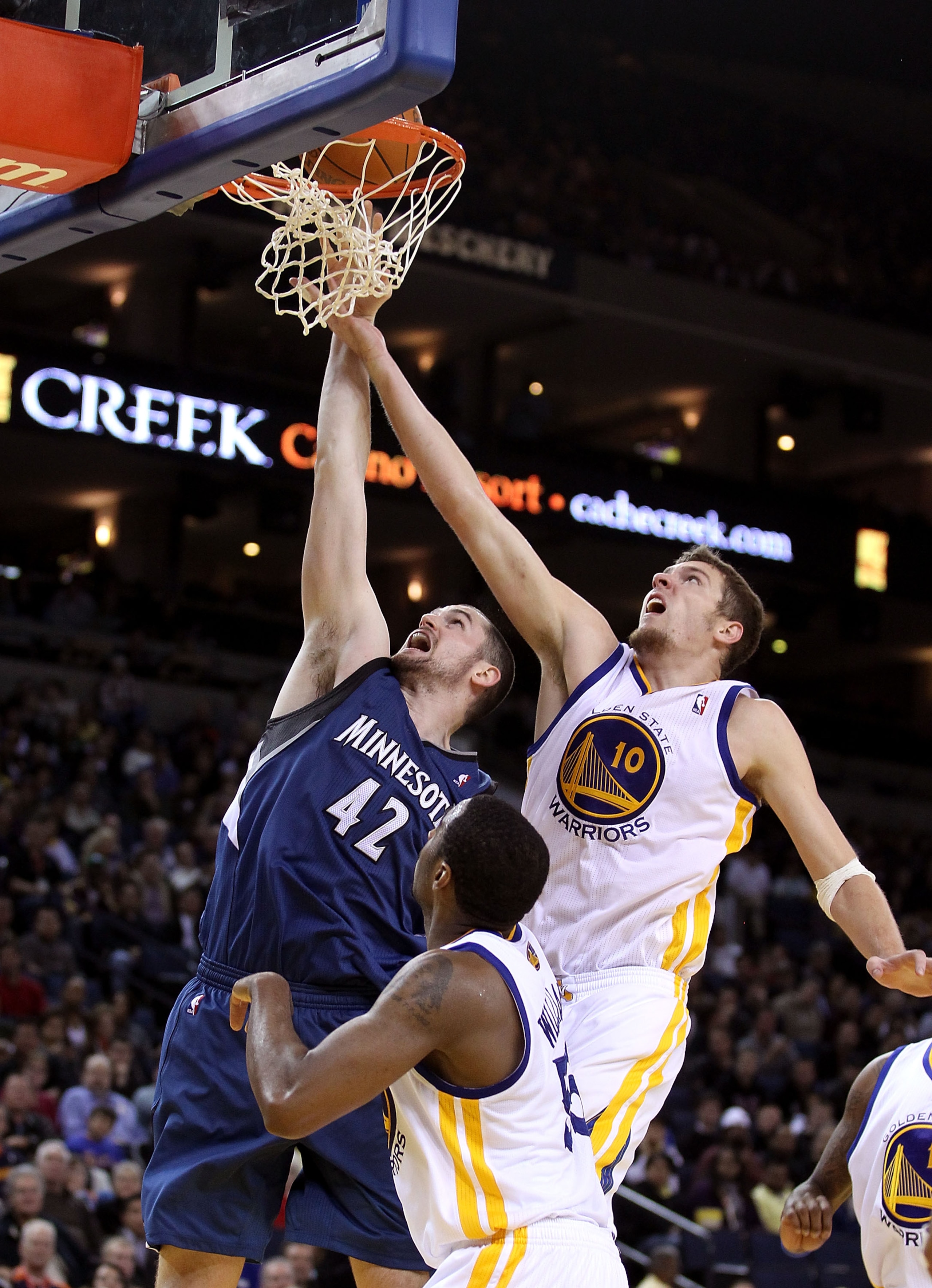 OAKLAND, CA - DECEMBER 14:  Kevin Love #42 of the Minnesota Timberwolves shoots over David Lee #10 of the Golden State Warriors at Oracle Arena on December 14, 2010 in Oakland, California.  NOTE TO USER: User expressly acknowledges and agrees that, by dow