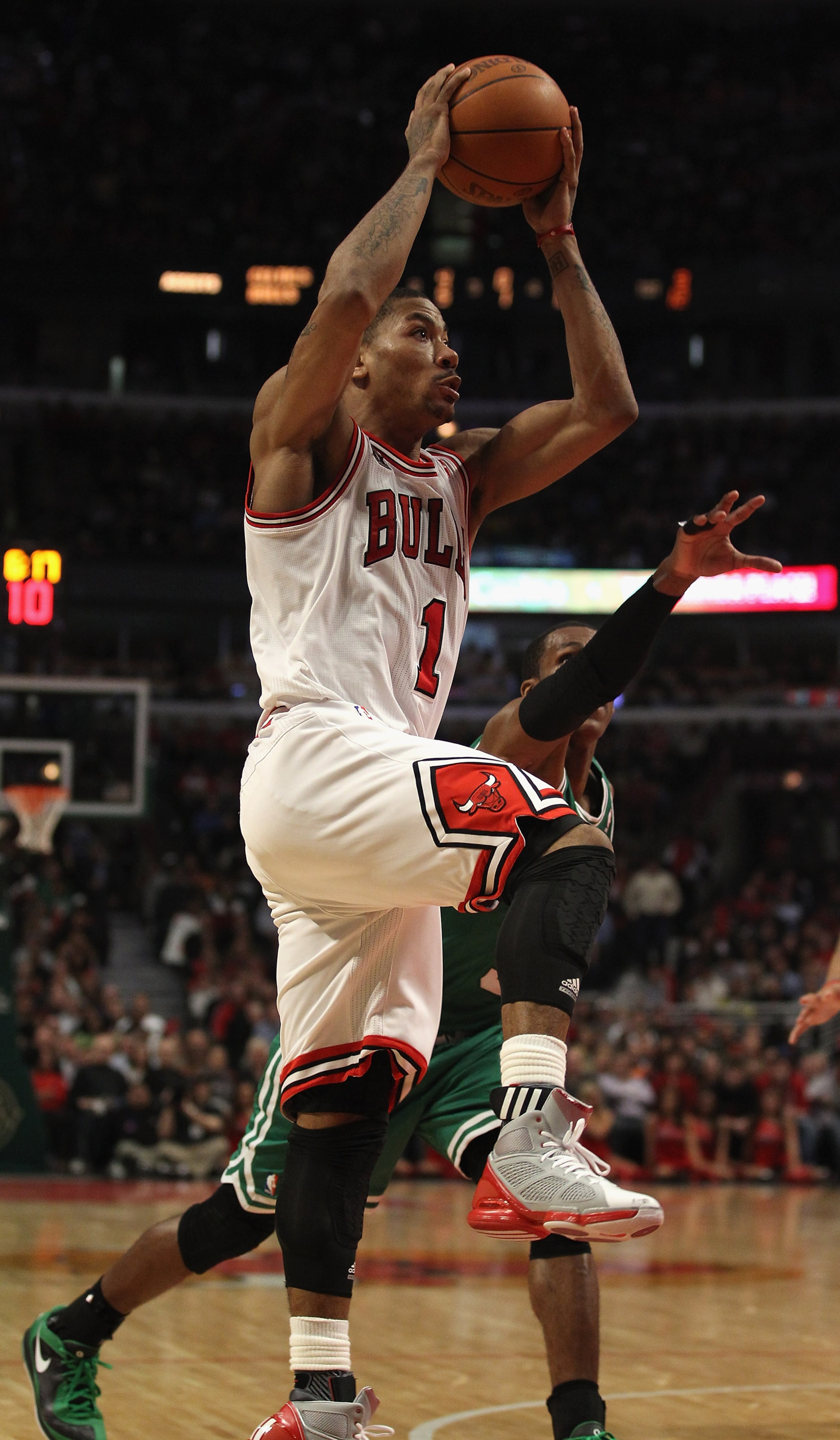 CHICAGO, IL - APRIL 07: Derrick Rose #1 of the Chicago Bulls goes up for a shot past Rajon Rondo #9 of the Boston Celtics at United Center on April 7, 2011 in Chicago, Illinois. The Bulls defeated the Celtics 97-81. NOTE TO USER: User expressly acknowledg