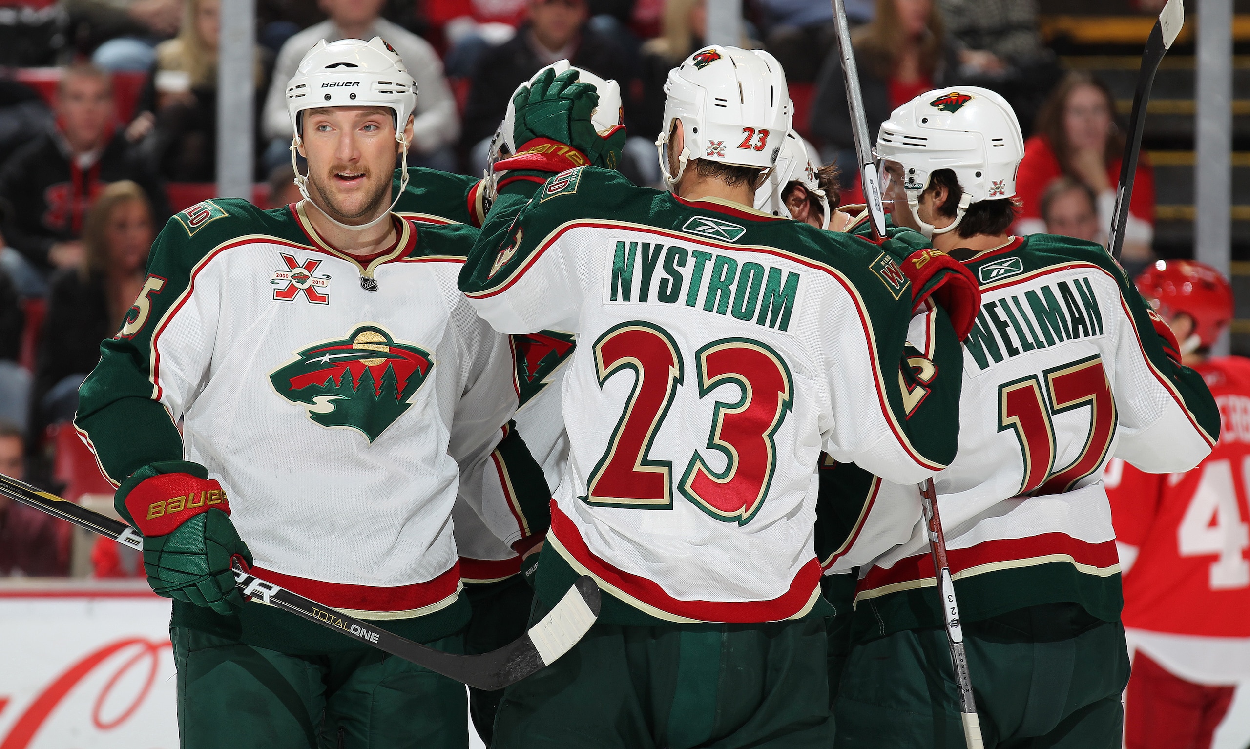 DETROIT, MI - NOVEMBER 19:  Cam Barker #25 and his teamamtes on the Minnesota Wild celebrate a goal in a game against the Detroit Red Wings on November 19, 2010 at the Joe Louis Arena in Detroit, Michigan. The Wild defeated the Wings 4-3 in overtime. (Pho