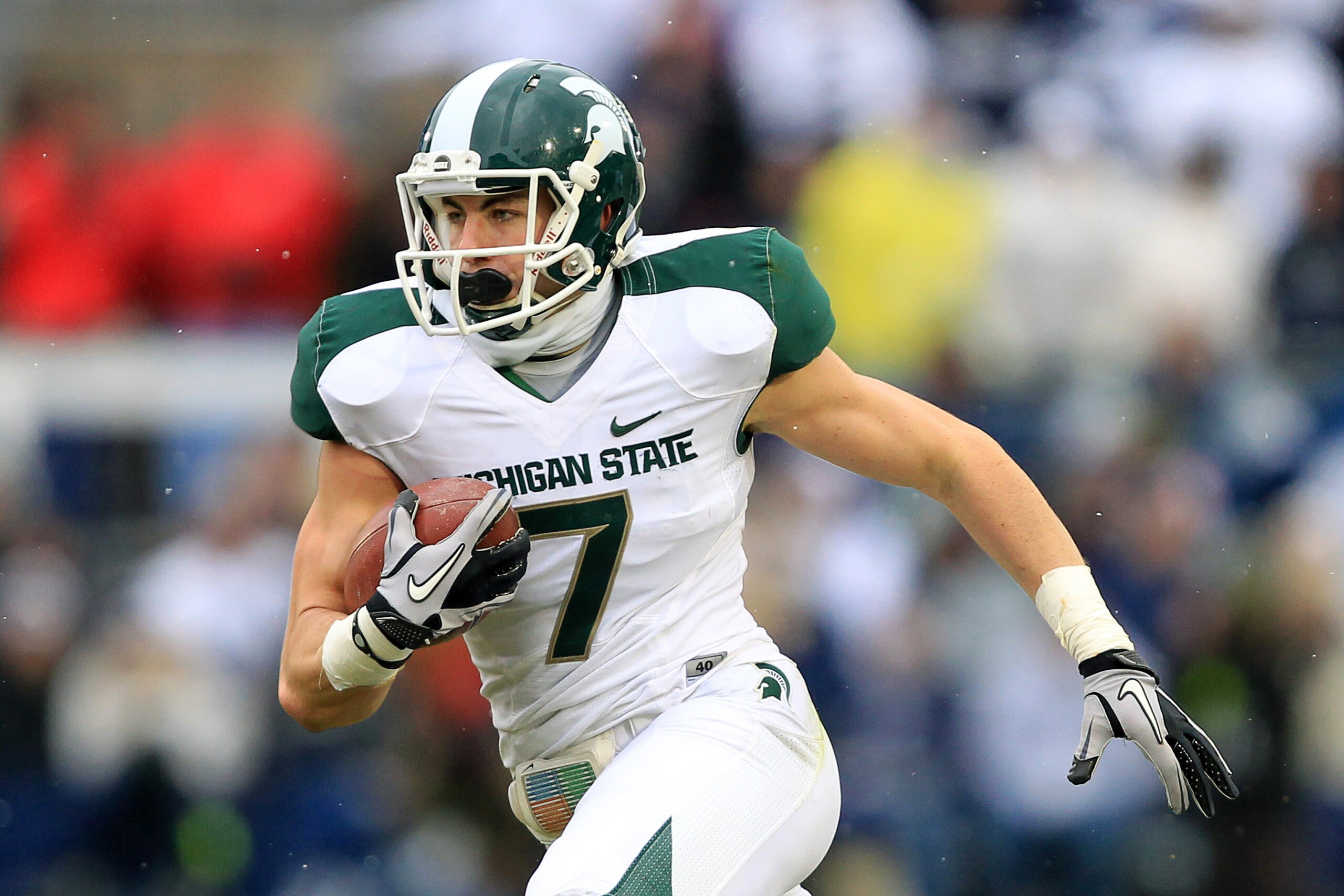 STATE COLLEGE, PA - NOVEMBER 27: Wide receiver Keith Nichol #7 of the Michigan State Spartans carries the ball during a game against the Penn State Nittany Lions on November 27, 2010 at Beaver Stadium in State College, Pennsylvania. The Spartans won 28-22