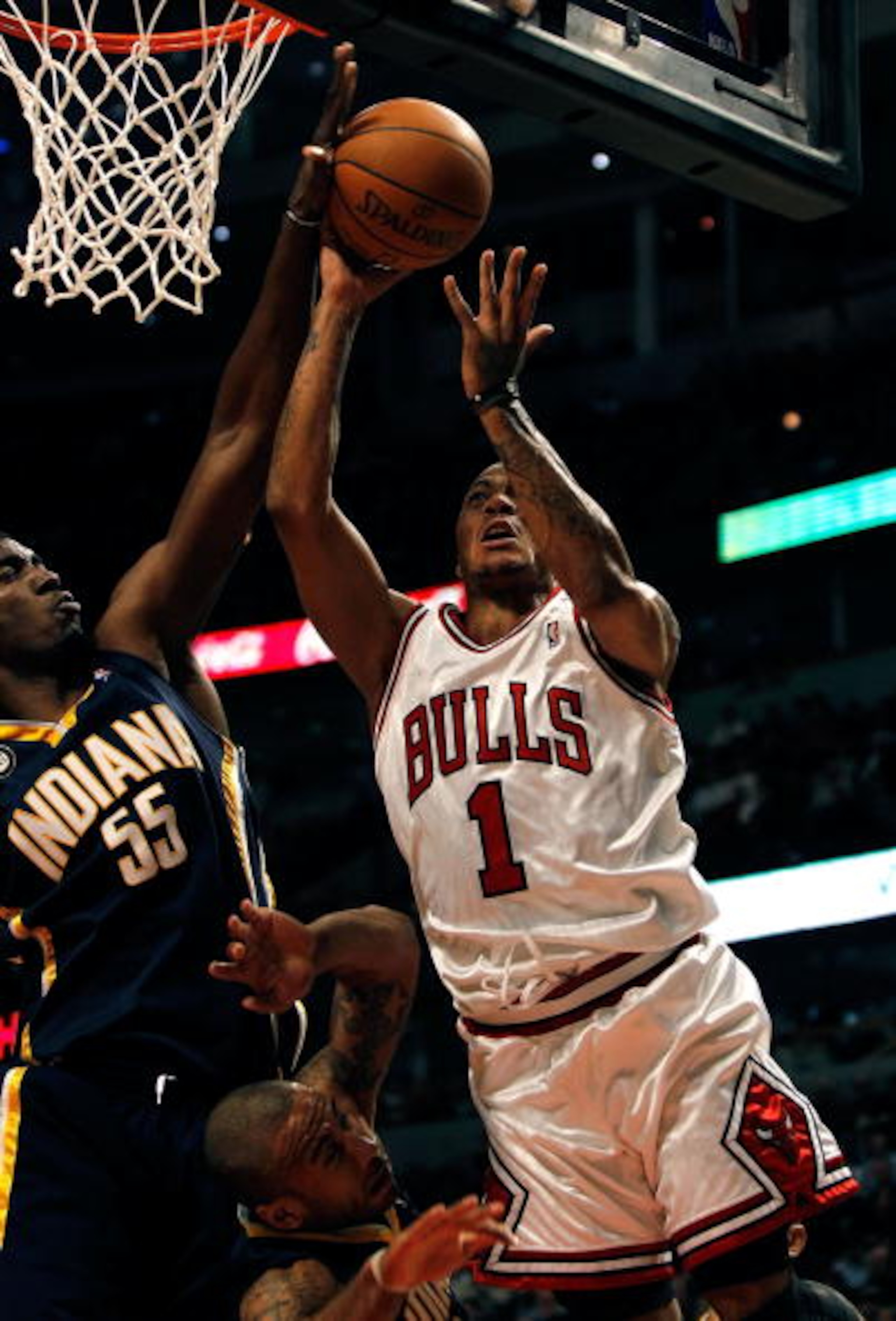 CHICAGO - FEBRUARY 24: Derrick Rose #1 of the Chicago Bulls goes up for a shot against Roy Hibbert #55 and Dahntay Jones #1 of the Indiana Pacers at the United Center on February 24, 2010 in Chicago, Illinois. The Bulls defeated the Pacers 120-110. NOTE T