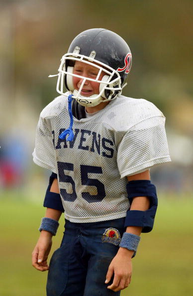 CARLSBAD, CA - NOVEMBER 9:  A player from the San Dieguito Ravens shows his emotions after losing to the Carlsbad Charging Lancers 18-0 during the Pop Warner Division Finals on November 9, 2002 at Carlsbad High School, in Carlsbad, California.  (Photo by 