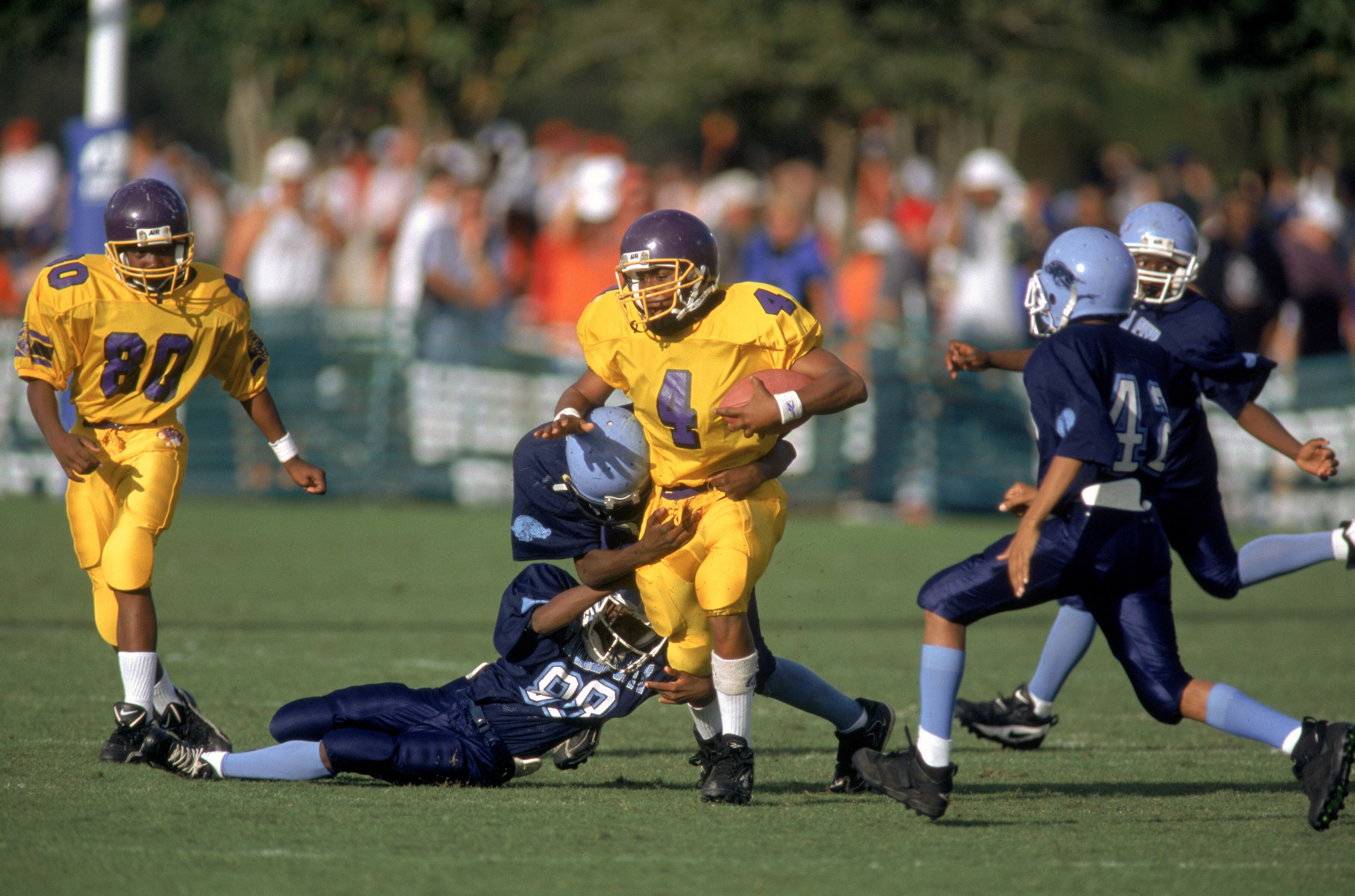 ORLANDO, FL - DECEMBER 12:  Frankie Oliver #4 of the Peewee football League runs with the ball during the Pop Warner Super Bowl at the Disney Wide World Of Sports Complex in Orlando, Florida on December 12th 1998. (Photo by:  Scott Halleran/Getty Images