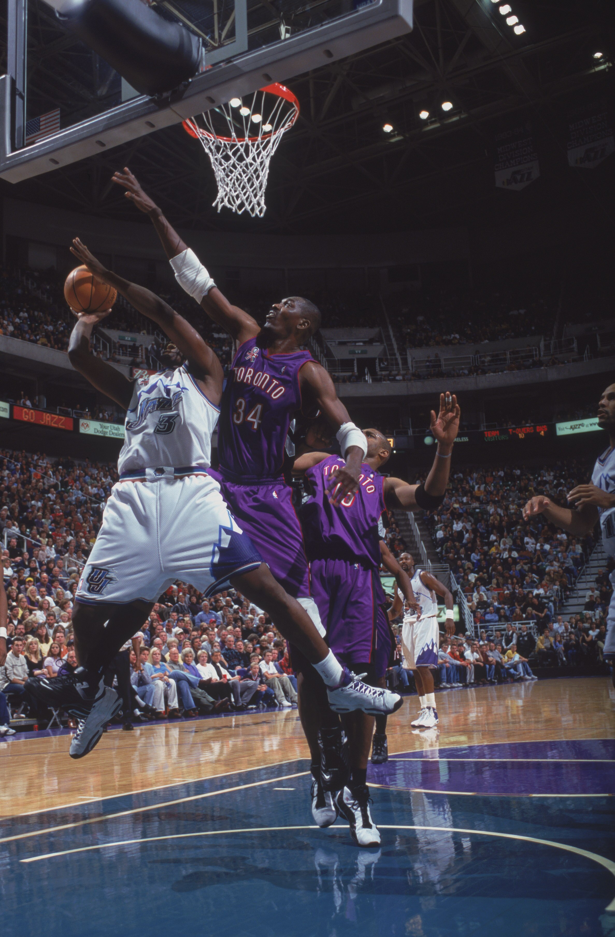 10 Nov 2001:  Hakeem Olajuwan #34 of the Toronto Raptors tries to block a shot made by Bryon Russell #3 of the Utah Jazz during the game at the Delta Center in Salt Lake City, Utah.  The Raptors defeated the Jazz 117-96.  NOTE TO USER: User expressly ackn