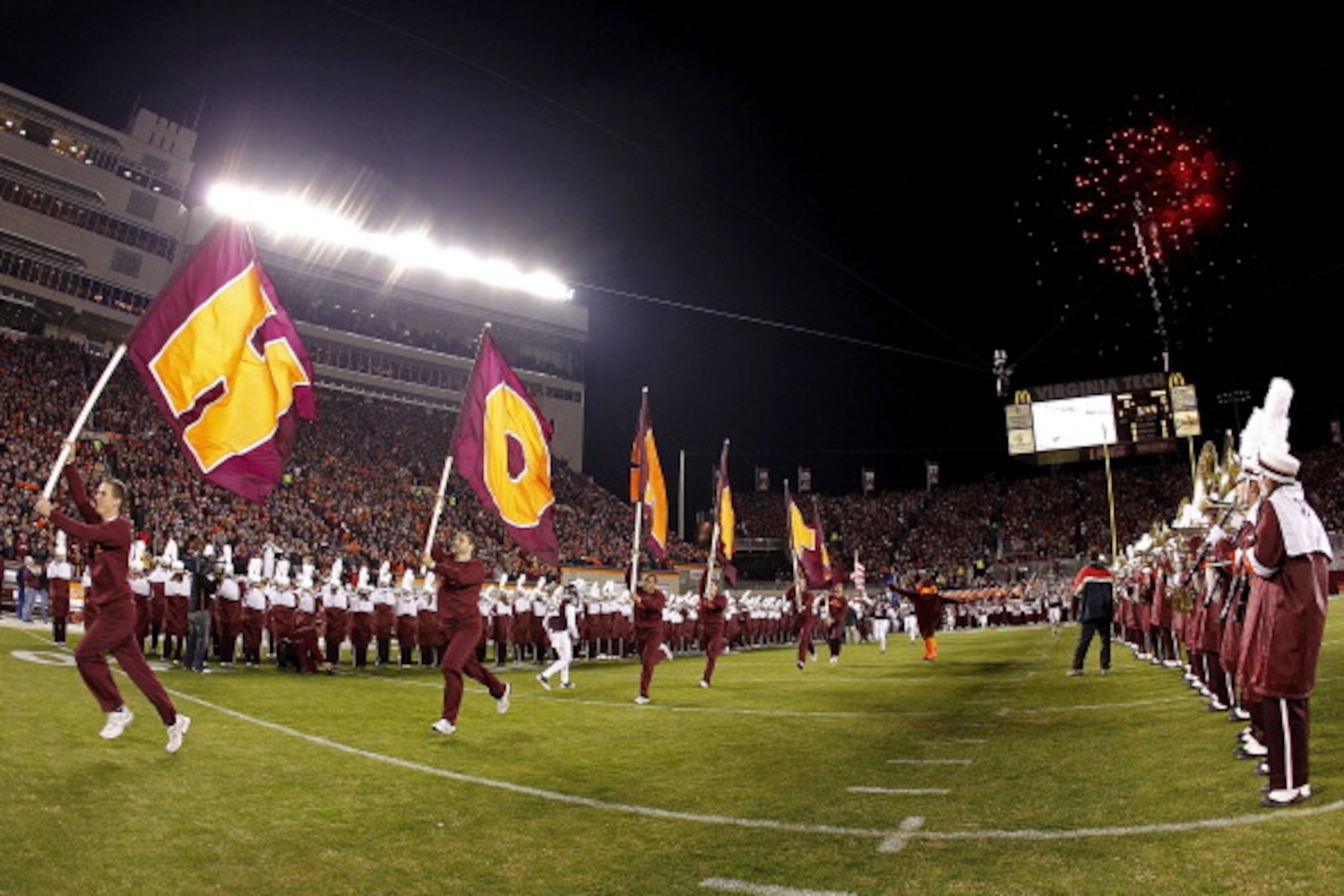 BLACKSBURG, VA - NOVEMBER 04: Cheerleaders from the Virginia Tech Hokies lead the players onto the field prior to the Hokies game against the Georgia Tech Yellow Jackets at Lane Stadium on November 4, 2010 in Blacksburg, Virginia.  (Photo by Geoff Burke/G