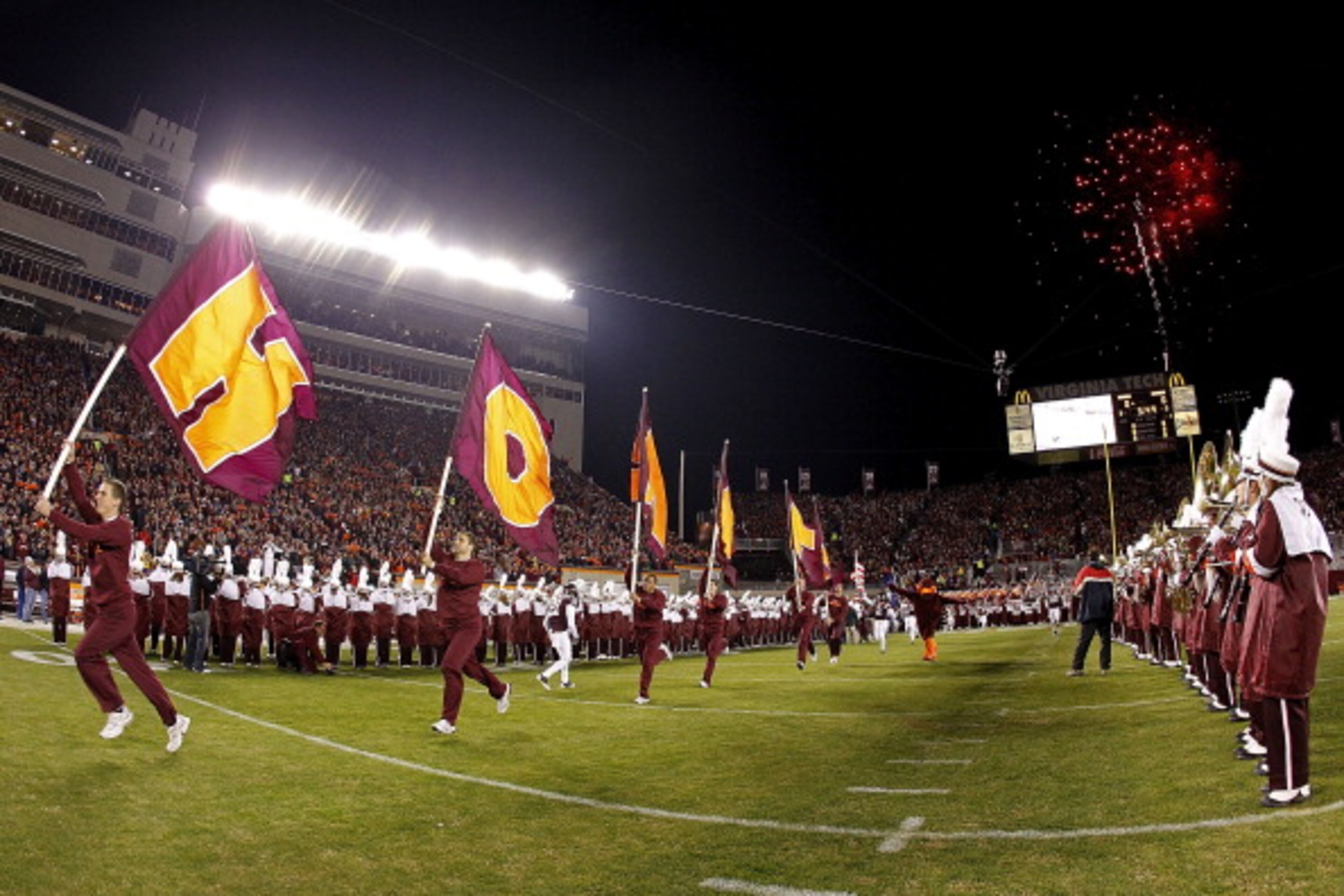 BLACKSBURG, VA - NOVEMBER 04: Cheerleaders from the Virginia Tech Hokies lead the players onto the field prior to the Hokies game against the Georgia Tech Yellow Jackets at Lane Stadium on November 4, 2010 in Blacksburg, Virginia.  (Photo by Geoff Burke/G