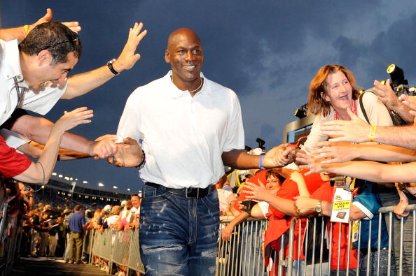 CONCORD, NC - MAY 22:  Former NBA Chicago Bulls gaurd Michael Jordon high-fives the crowd during pre-race ceremonies prior to the start of the NASCAR Sprint All-Star Race at Charlotte Motor Speedway on May 22, 2010 in Concord, North Carolina.  (Photo by J