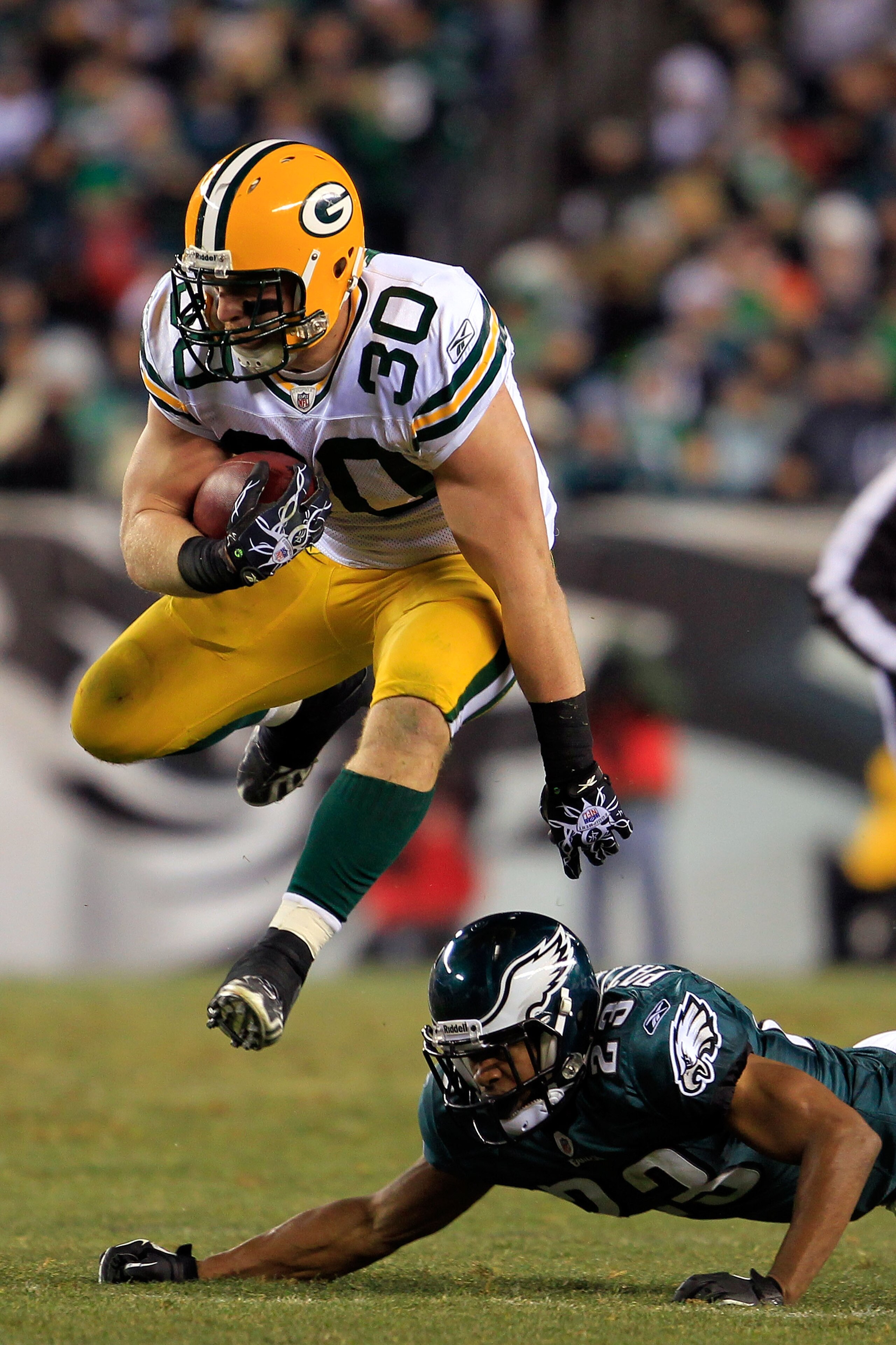 PHILADELPHIA, PA - JANUARY 09:  John Kuhn #30 of the Green Bay Packers avoids the tackle of Dimitri Patterson #23 of the Philadelphia Eagles during the 2011 NFC wild card playoff game at Lincoln Financial Field on January 9, 2011 in Philadelphia, Pennsylv