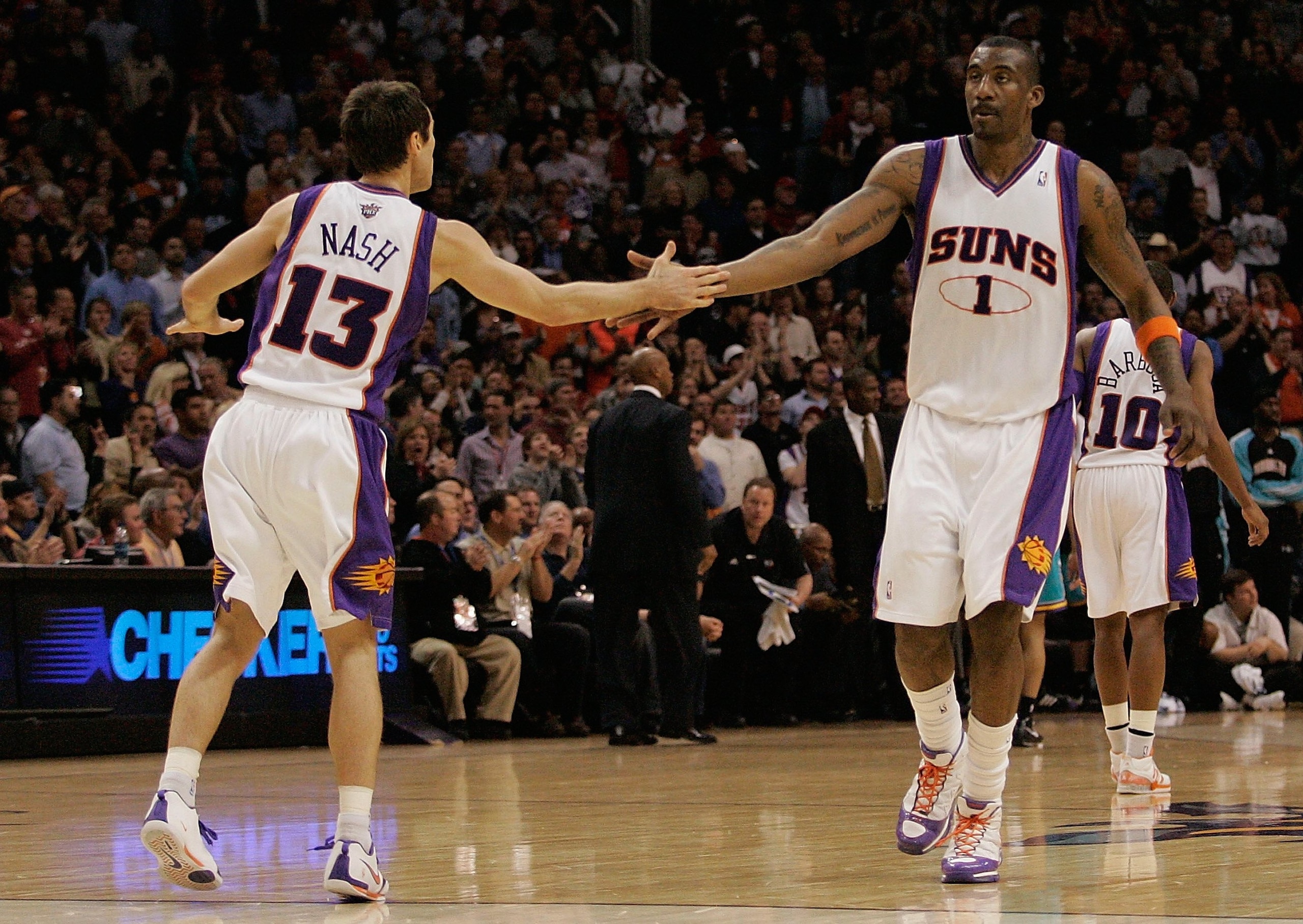 PHOENIX - FEBRUARY 6:  Steve Nash #13 and Amare Stoudemire #1 of the Phoenix Suns celebrate during the game against the New Orleans Hornets on February 6, 2008 at US Airways Center in Phoenix, Arizona.  The Hornets won in double overtime 132-130.   NOTE T