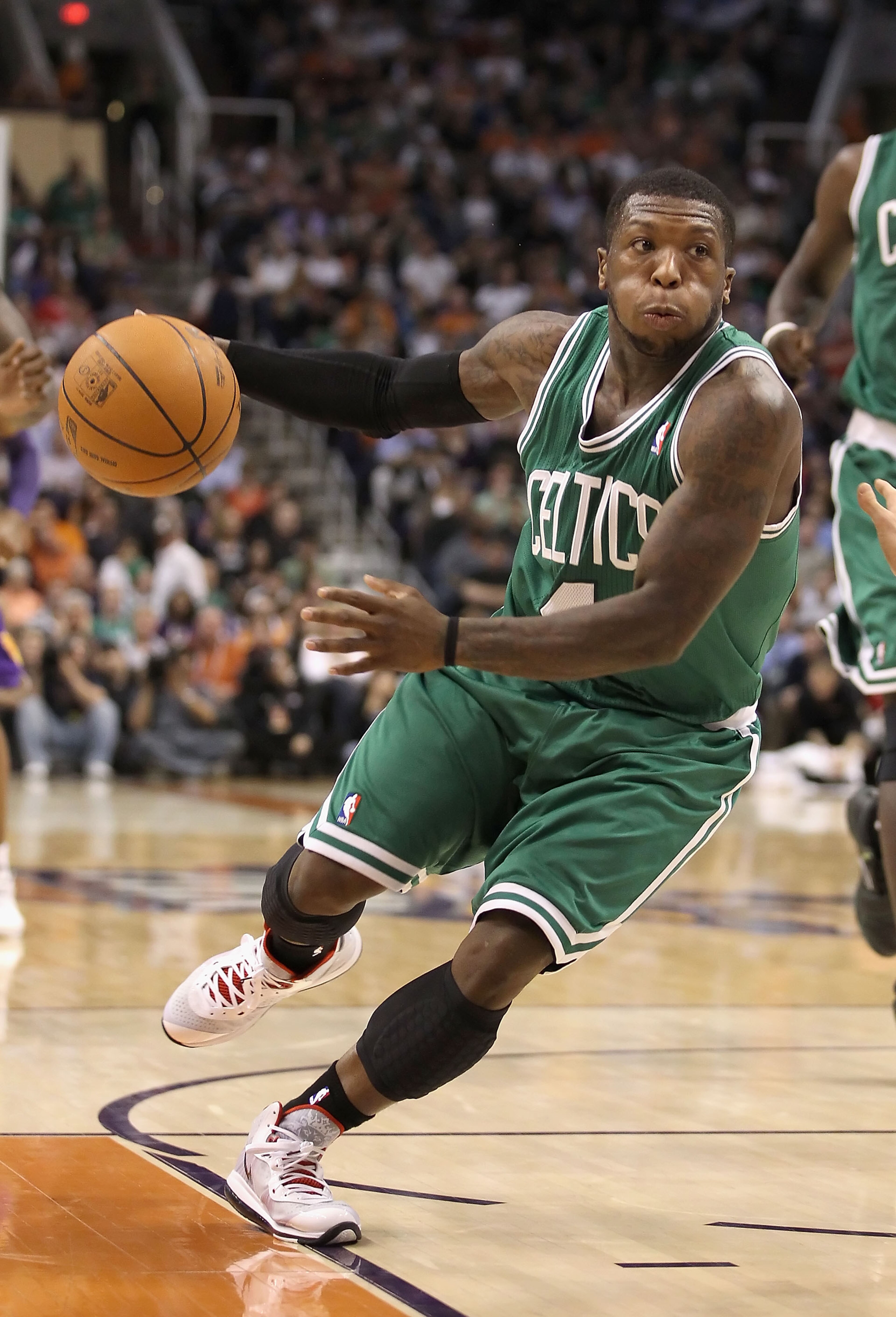 PHOENIX, AZ - JANUARY 28:  Nate Robinson #4 of the Boston Celtics handles the ball during the NBA game against the Phoenix Suns at US Airways Center on January 28, 2011 in Phoenix, Arizona. The Suns defeated the Celtics 88-71. NOTE TO USER: User expressly