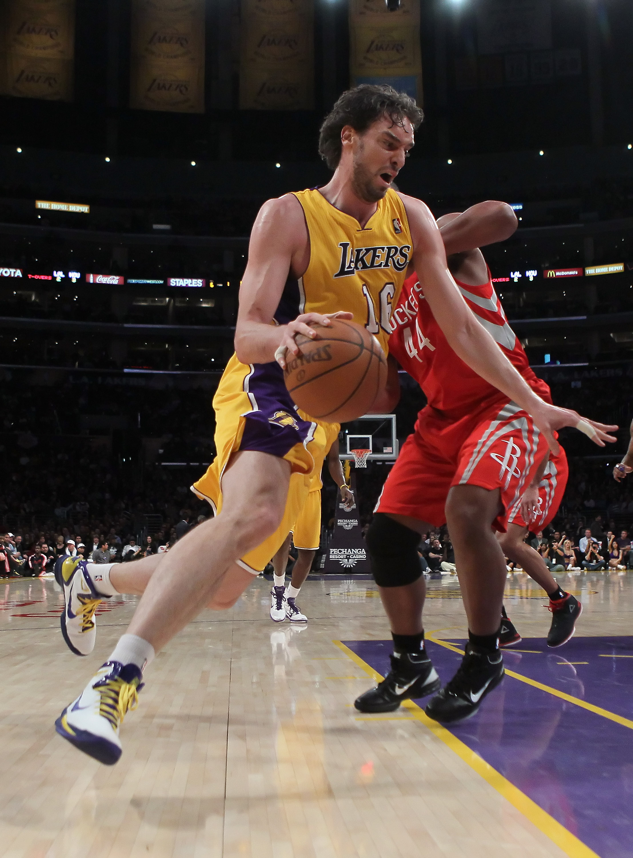 LOS ANGELES, CA - FEBRUARY 01:  Pau Gasol #16 of the Los Angeles Lakers drives around Chuck Hayes #44 of the Houston Rockets in the first half at Staples Center on February 1, 2011 in Los Angeles, California. The Lakers defeated the Rockets 114-106. NOTE