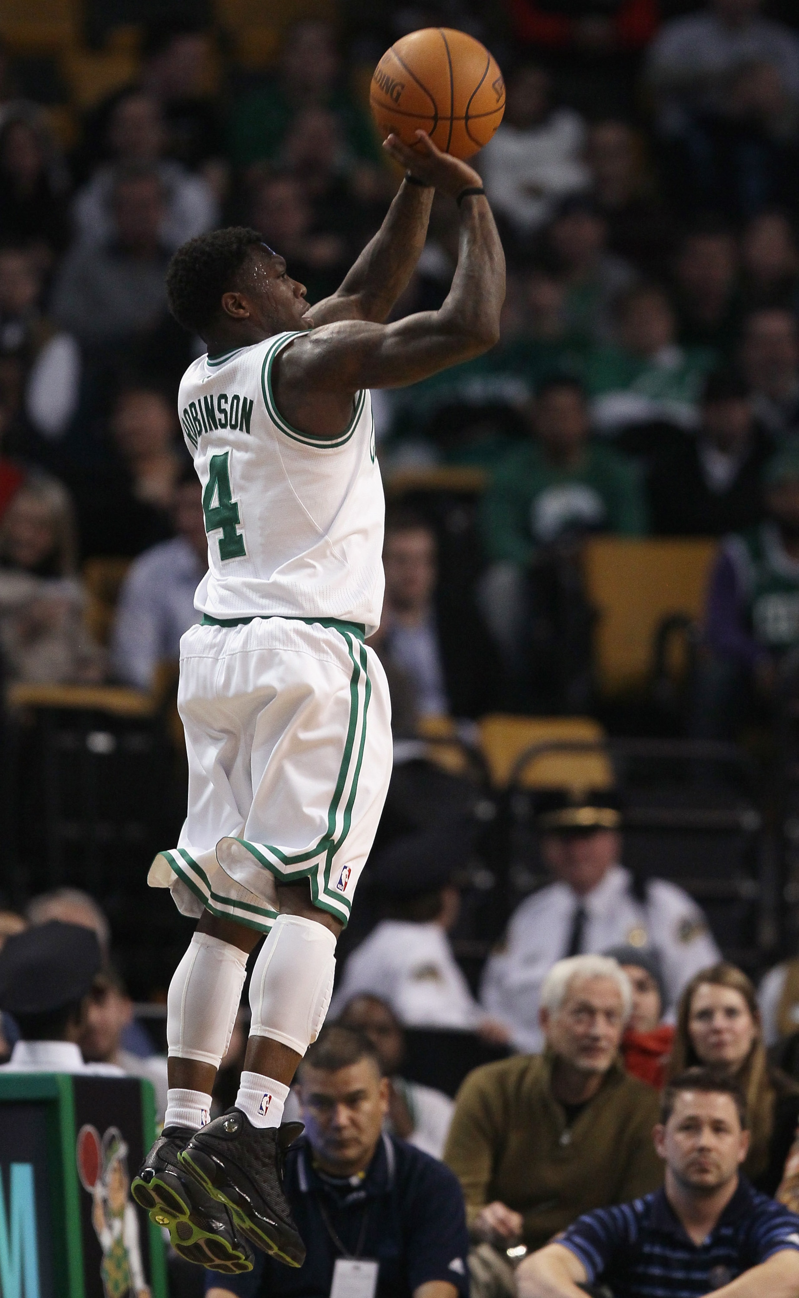 BOSTON, MA - DECEMBER 08:  Nate Robinson #4 of the Boston Celtics makes a three point basket in the second half against the Denver Nuggets on December 8, 2010 at the TD Garden in Boston, Massachusetts. The Celtics defeated the Nuggets 105-89. NOTE TO USER