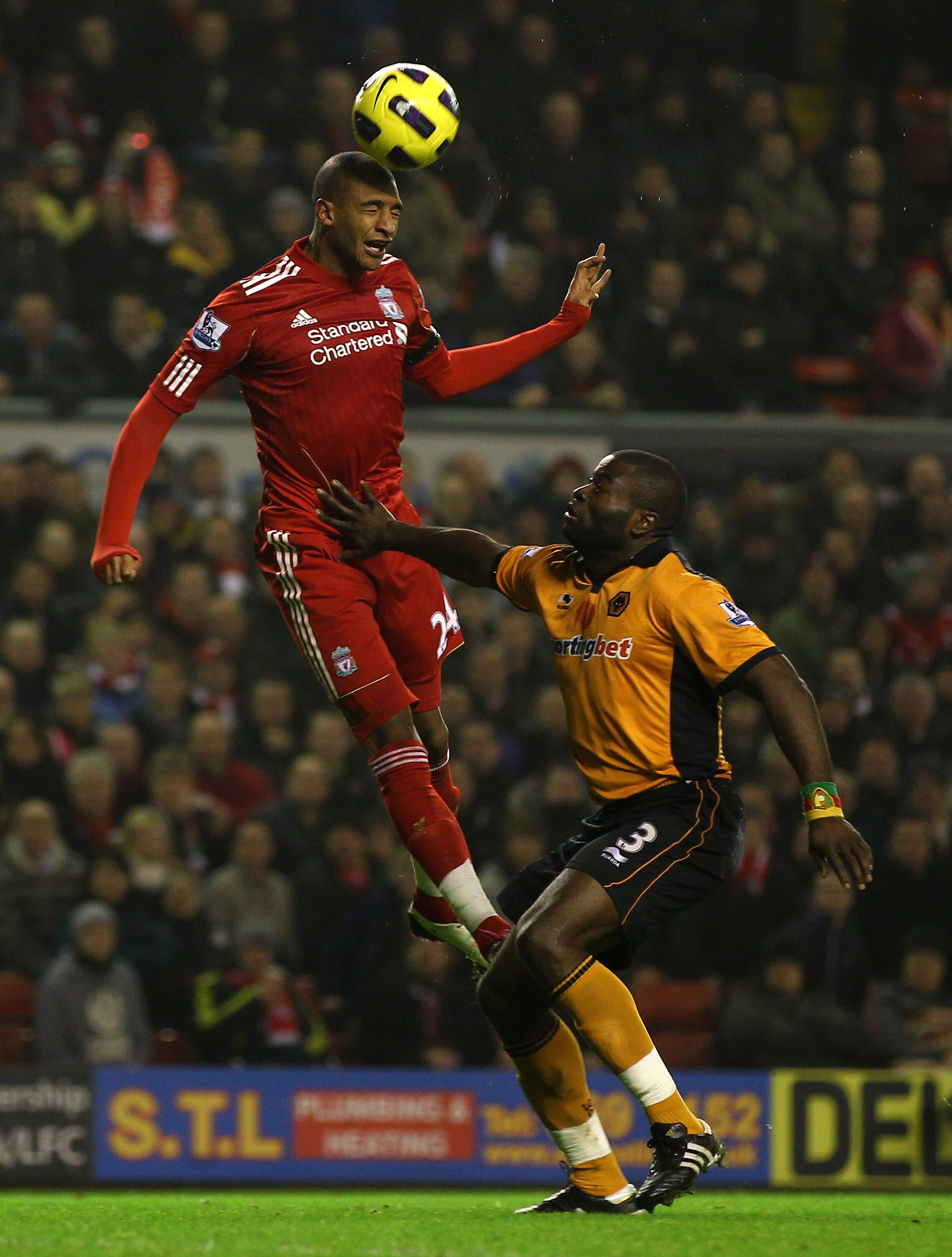 LIVERPOOL, ENGLAND - DECEMBER 29:  George Elokobi of Wolverhampton Wanderers challenges David Ngog of Liverpool during the Barclays Premier League match between Liverpool and Wolverhampton Wanderers at Anfield on December 29, 2010 in Liverpool, England. (