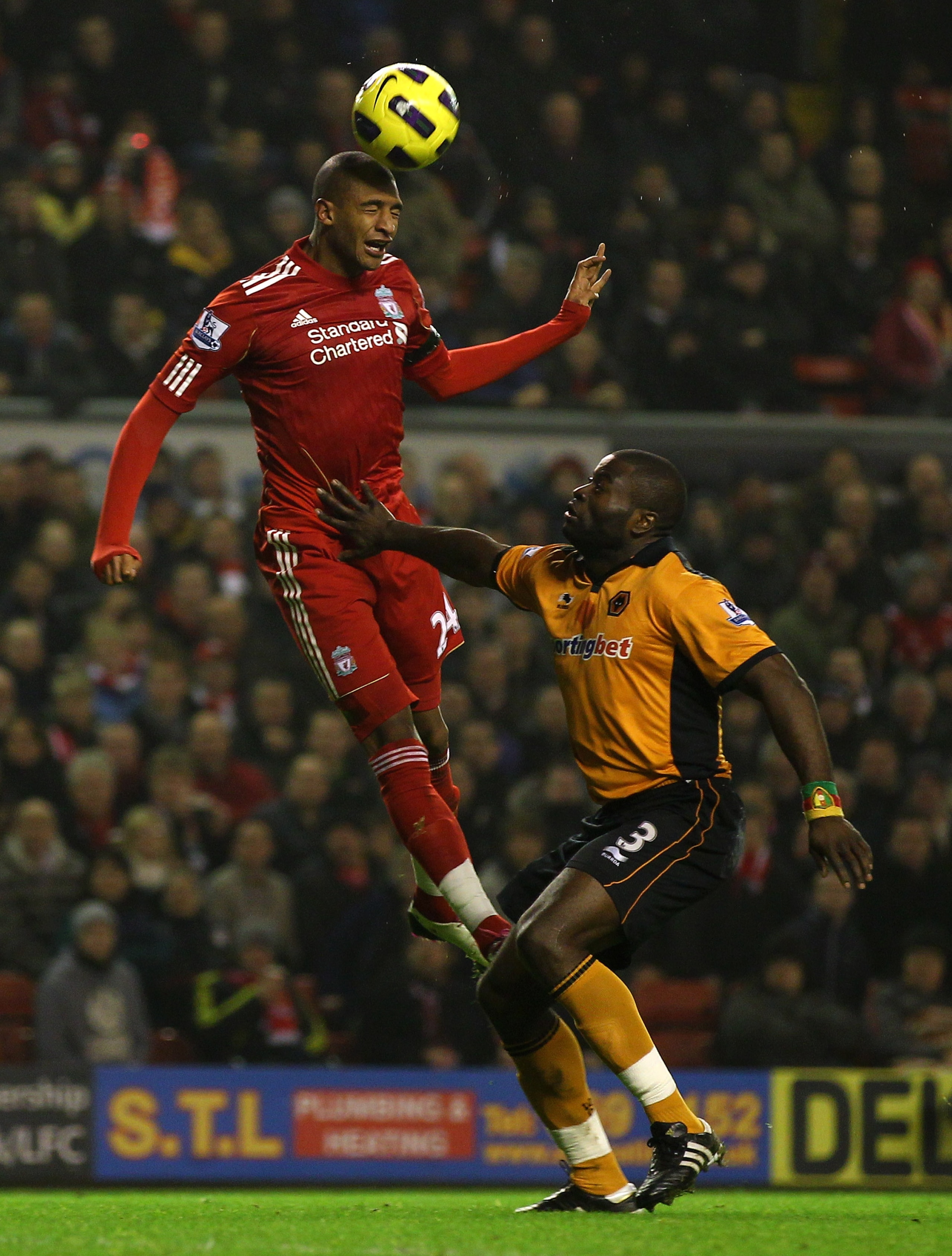 LIVERPOOL, ENGLAND - DECEMBER 29:  George Elokobi of Wolverhampton Wanderers challenges David Ngog of Liverpool during the Barclays Premier League match between Liverpool and Wolverhampton Wanderers at Anfield on December 29, 2010 in Liverpool, England. (