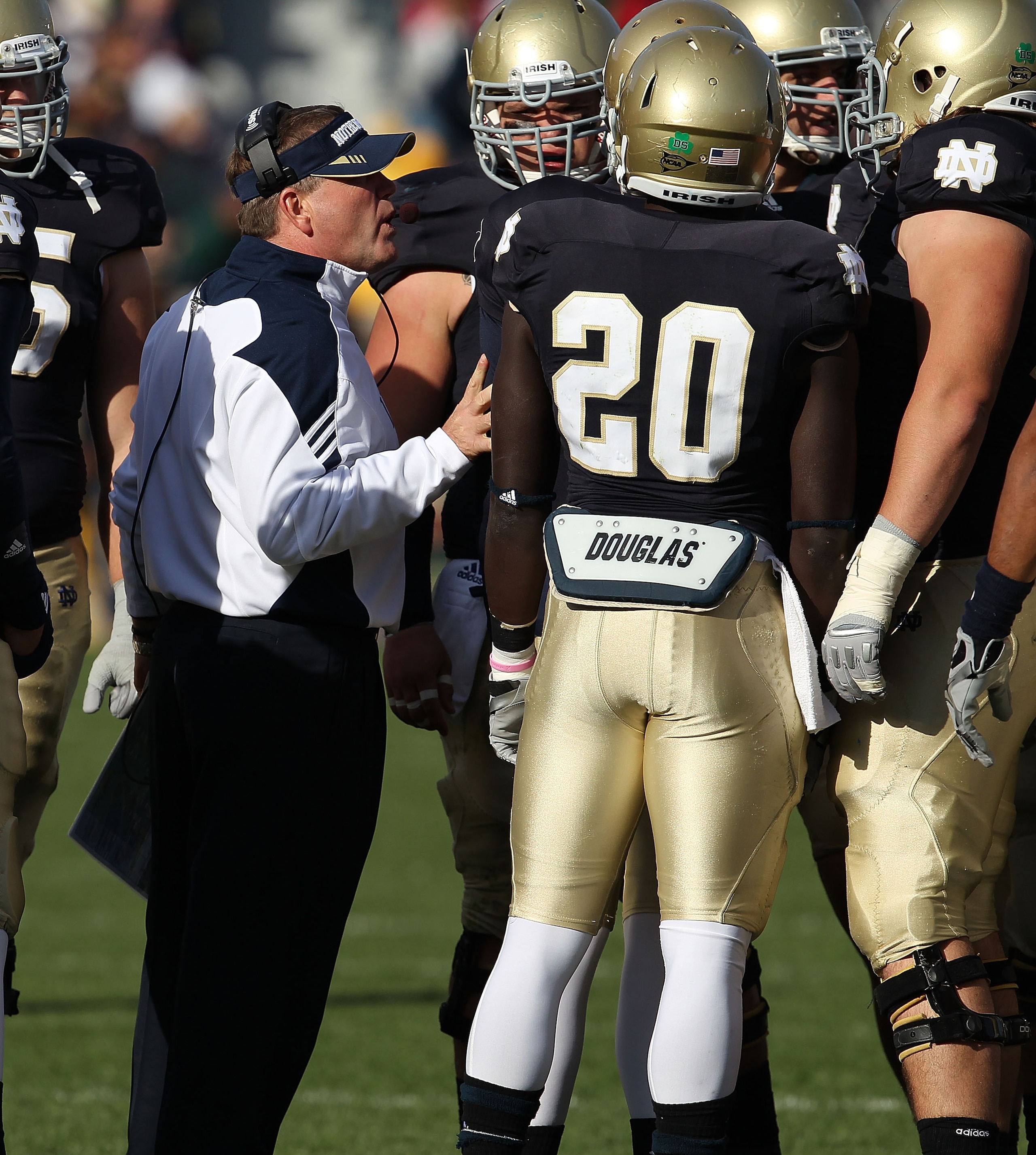 SOUTH BEND, IN - OCTOBER 30: Head coach Brian Kelly of the Notre Dame Fighting Irish talks to his offensive team including Cierre Wood #20 during a time-out against the Tulsa Golden Hurricane at Notre Dame Stadium on October 30, 2010 in South Bend, Indian