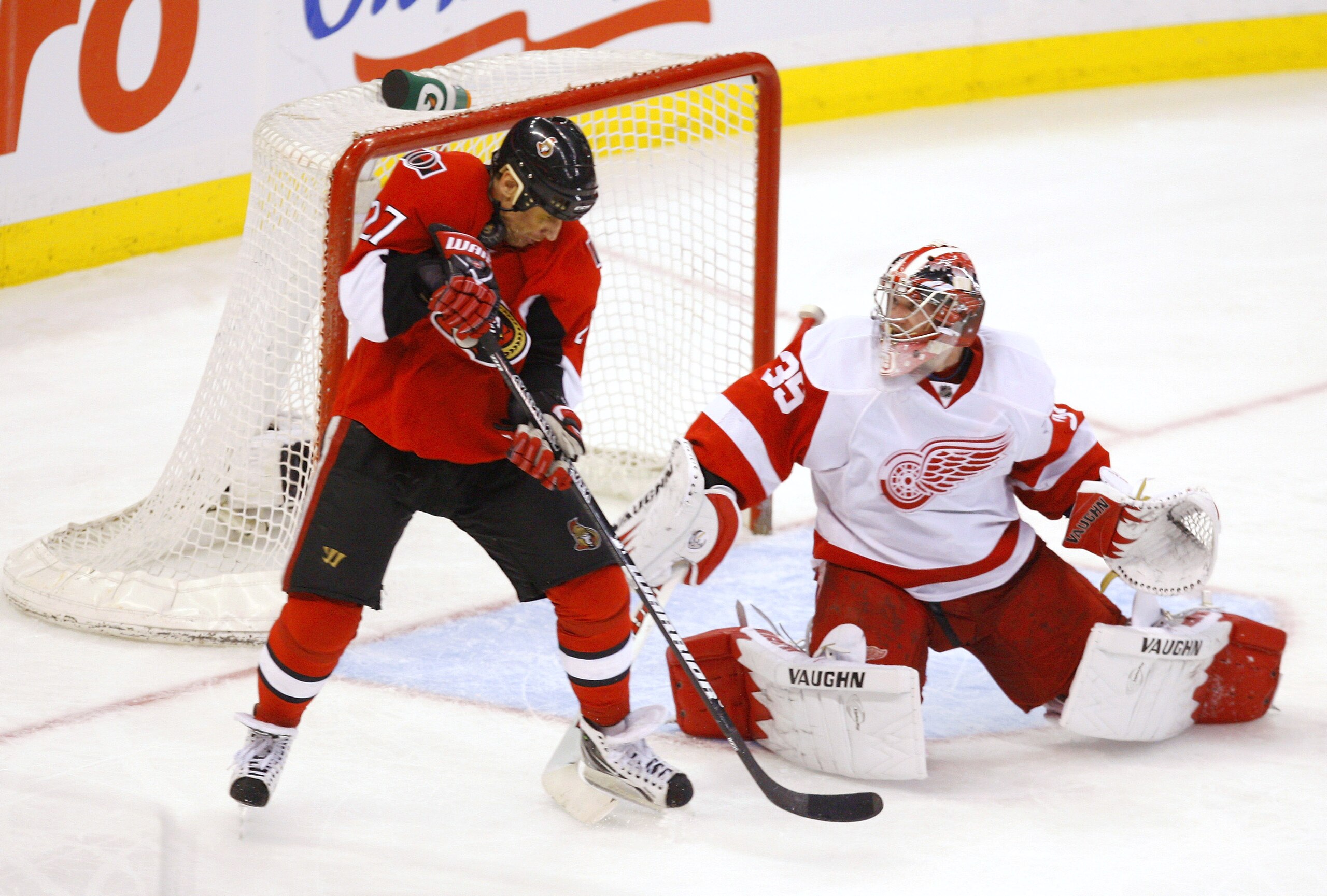 OTTAWA, CANADA - FEBRUARY 02:  Jimmy Howard #35 of the Detroit Red Wings makes a stick save deflecting the puck up into the equipment of Alex Kovalev #27 of the Ottawa Senators in a game at Scotiabank Place on February 2, 2011 in Ottawa, Ontario, Canada.