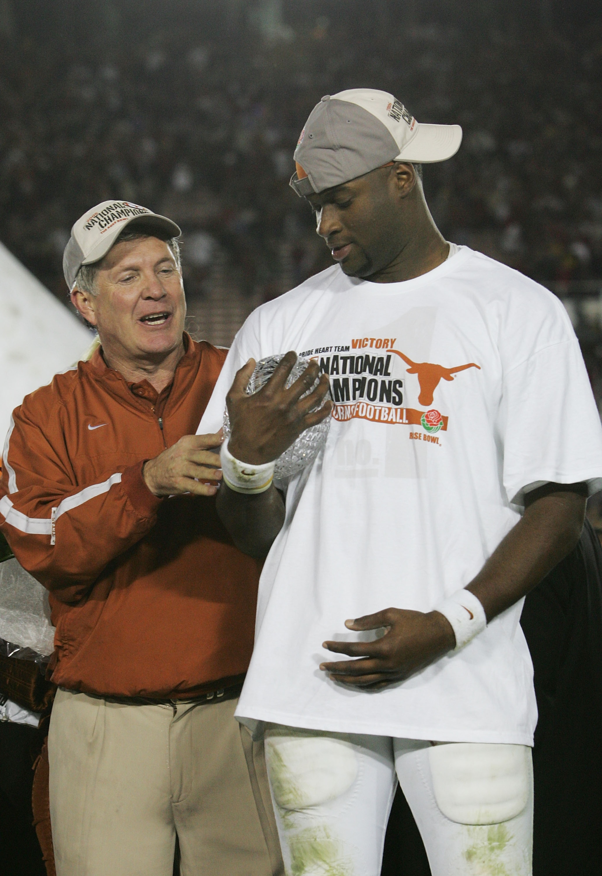 PASADENA, CA - JANUARY 04: Head coach Mack Brown of the Texas Longhorns celebrates with Vince Young after defeating the USC Trojans 41-38 to win the BCS National Championship Rose Bowl Game on January 4, 2006 in Pasadena, California. (Photo by Stephen D PASADENA, CA - JANUARY 04: Head coach Mack Brown of the Texas Longhorns celebrates with Vince Young after defeating the USC Trojans 41-38 to win the BCS National Championship Rose Bowl Game on January 4, 2006 in Pasadena, California. (Photo by Stephen D