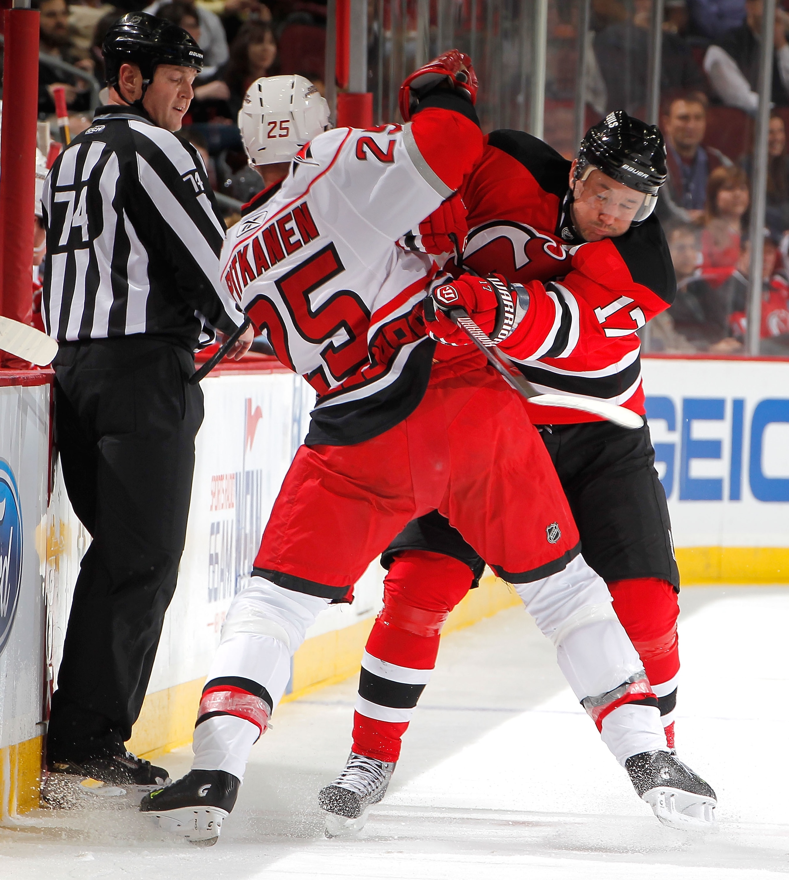 NEWARK, NJ - FEBRUARY 08:  Joni Pitkanen #25 of the Carolina Hurricanes is checked by Ilya Kovalchuk #17 of the New Jersey Devils during the second period of an NHL hockey game at the Prudential Center on February 8, 2011 in Newark, New Jersey.  (Photo by