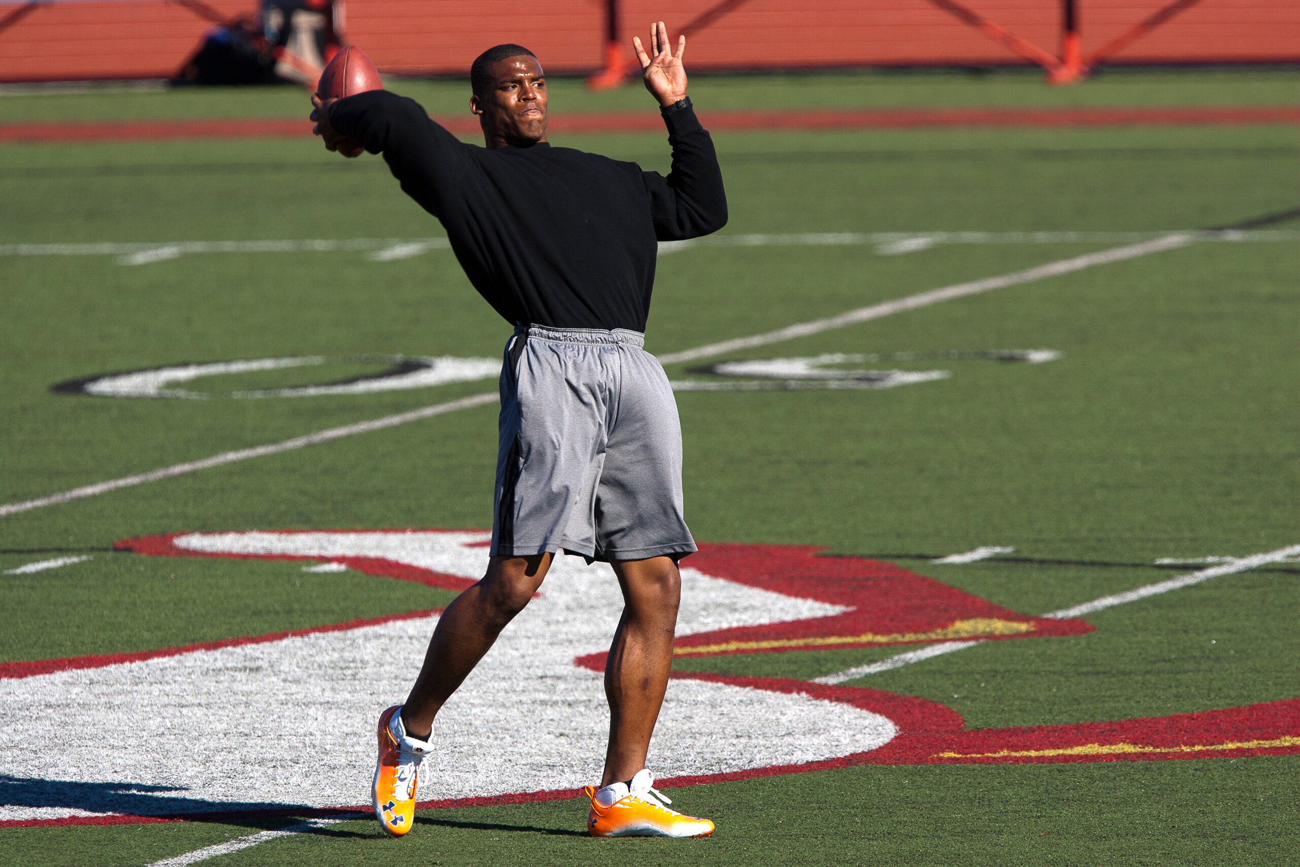 SAN DIEGO, CA - FEBRUARY 10:  2010 Heisman Trophy winning quarterback Cam Newton of the Auburn Tigers throws the ball during his workout routine for the media at Cathedral High School's sports stadium on February 10, 2011 in San Diego, California.  (Photo