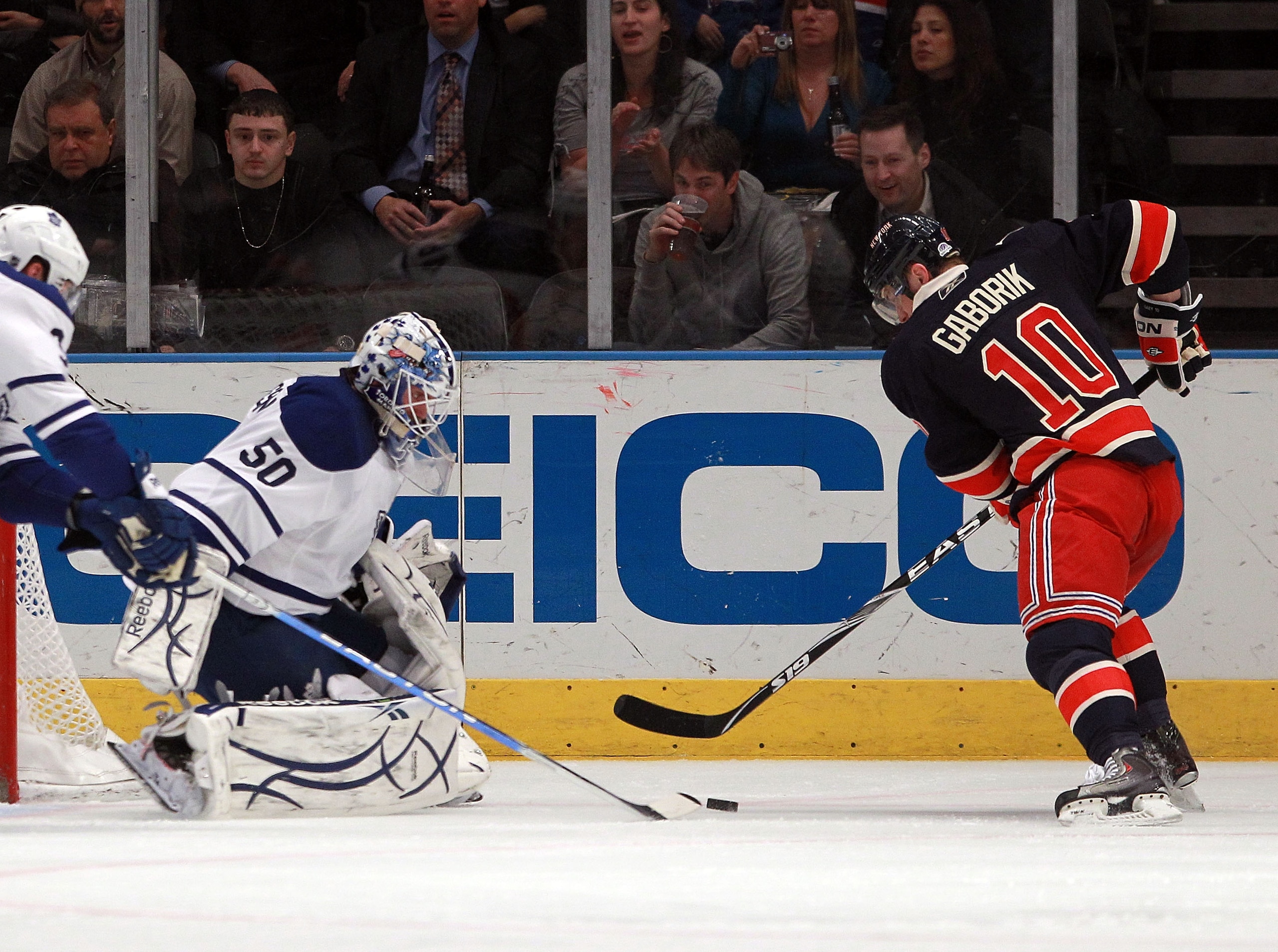 NEW YORK, NY - JANUARY 19: Marian Gaborik #10 of the New York Rangers dekes around Jonas Gustavsson #50 of the Toronto Maple Leafs to score against the Toronto Maple Leafs 10:55 of the first period at Madison Square Garden on January 19, 2011 in New York
