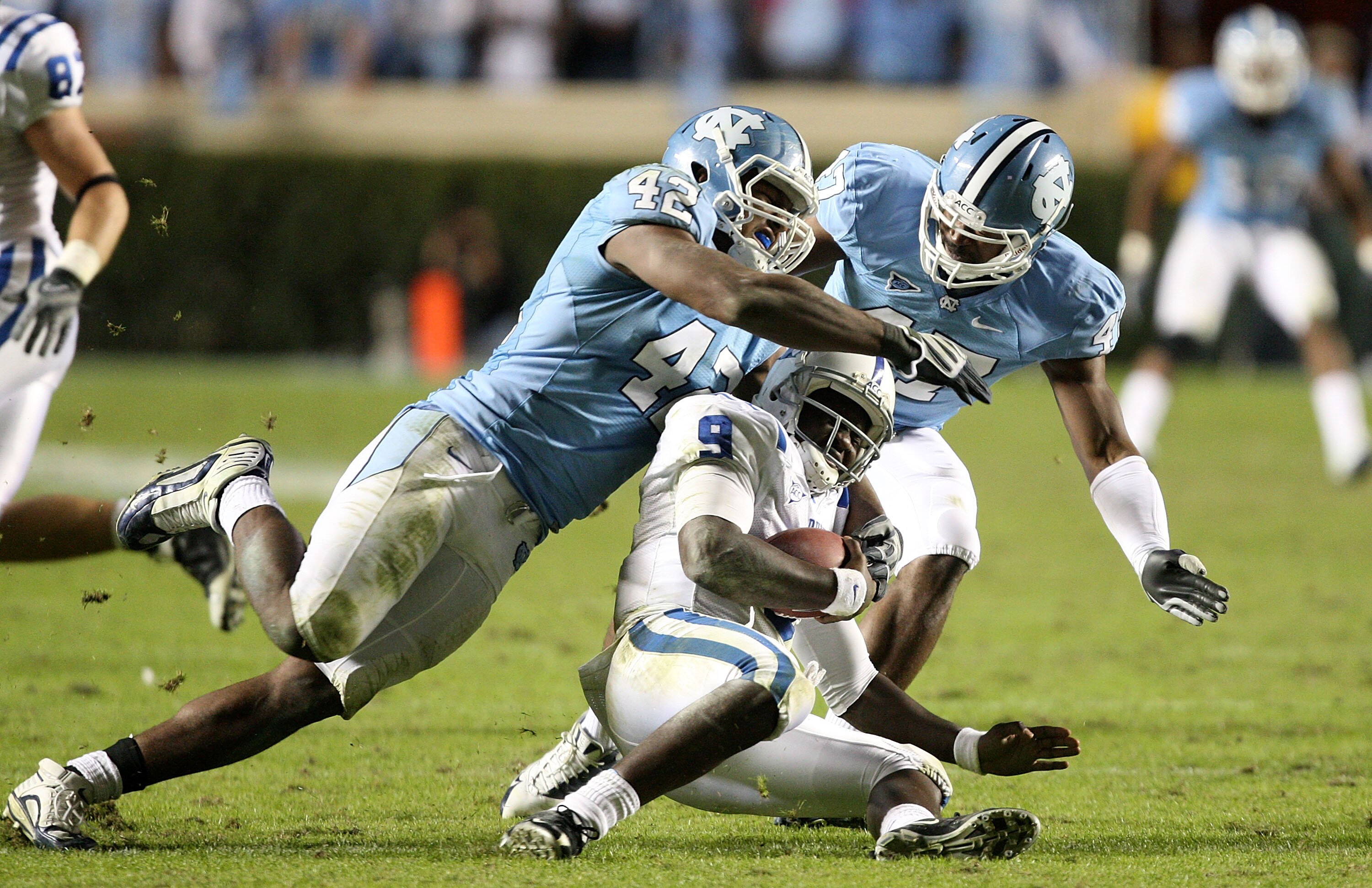CHAPEL HILL, NC - NOVEMBER 07:  Thaddeus Lewis #9 of the Duke Blue Devils is sacked by Robert Quinn #42 of the North Carolina Tar Heels during their game at Kenan Stadium on November 7, 2009 in Chapel Hill, North Carolina.  (Photo by Streeter Lecka/Getty