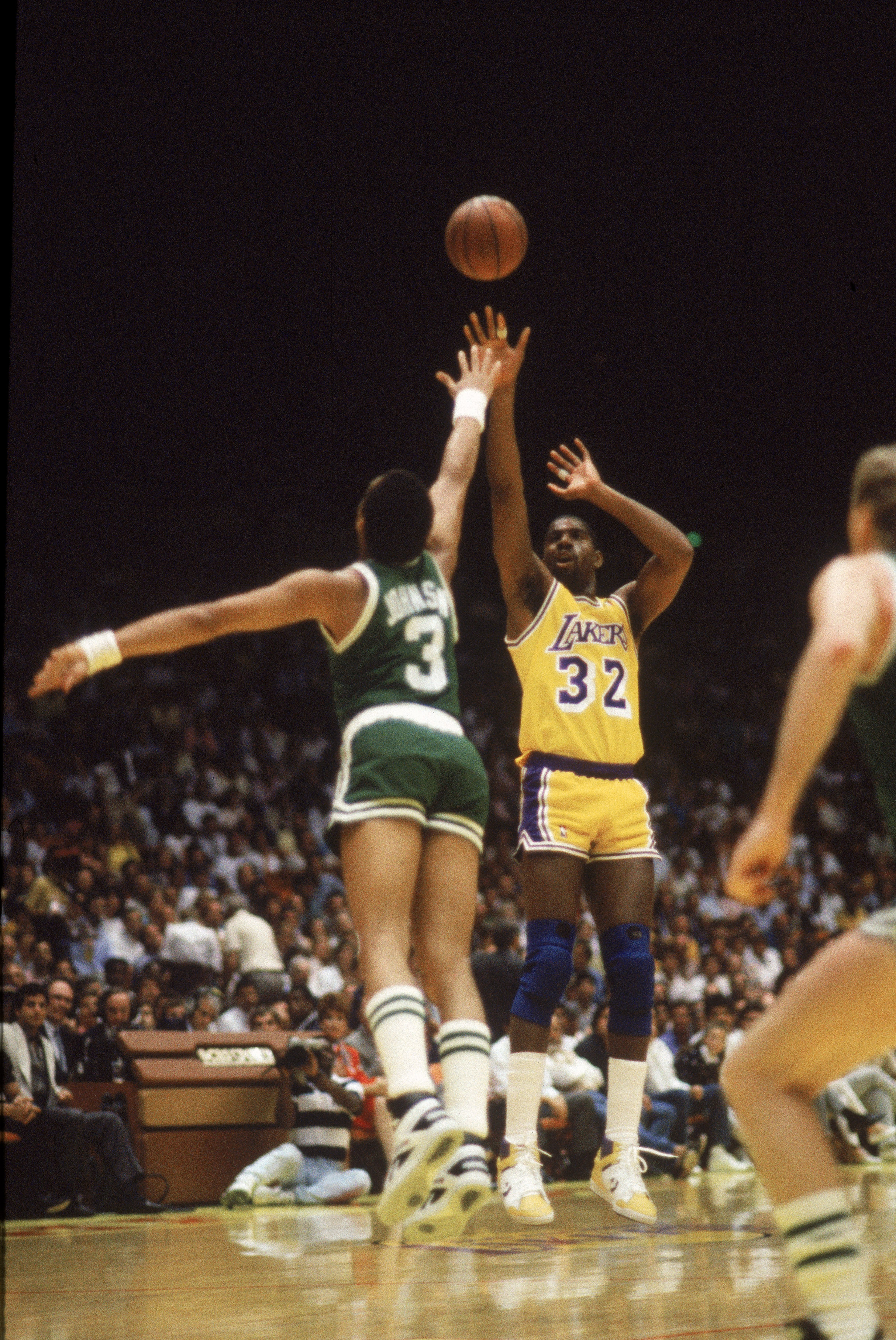 LOS ANGELES - 1987:  Magic Johnson #32 of the Los Angeles Lakers shoots over Dennis Johnson #3 of the Boston Celtics during an NBA Finals game at the Great Western Forum in Los Angeles, California in 1987. (Photo by: Mike Powell/Getty Images)