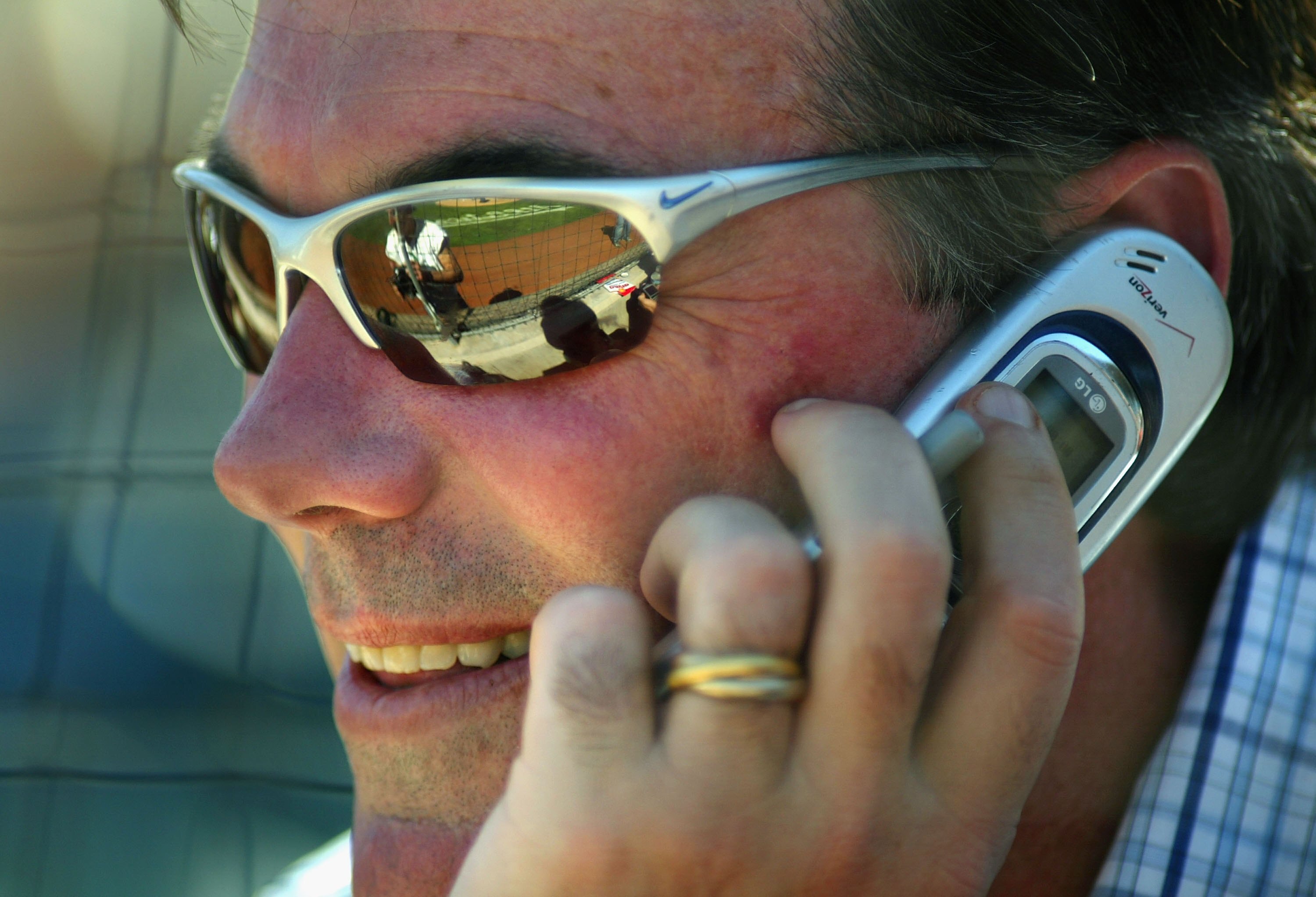 PHOENIX - MARCH 03:  General manager Billy Beane of the Oakland Athletics talks on the phone during the MLB Spring Training game against the Milwaukee Brewers at Phoenix Municipal Stadium on March 3, 2006 in Phoenix, Arizona.  The Brewers defeated the A's