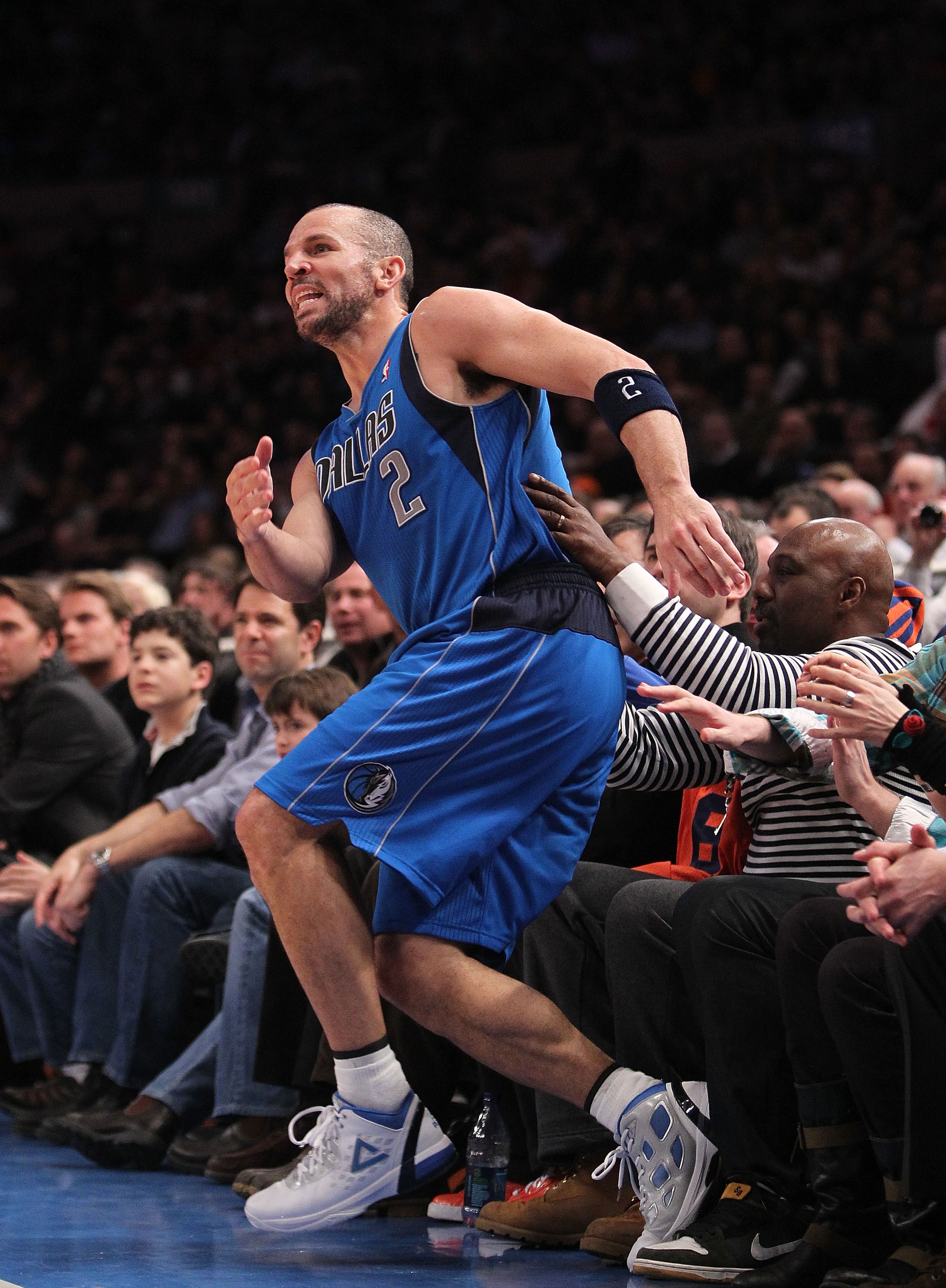 NEW YORK, NY - FEBRUARY 02: Jason Kidd #2 of the Dallas Mavericks trips on the front row after hitting a three pointer against the New York Knicks at Madison Square Garden on February 2, 2011 in New York City. NOTE TO USER: User expressly acknowledges and