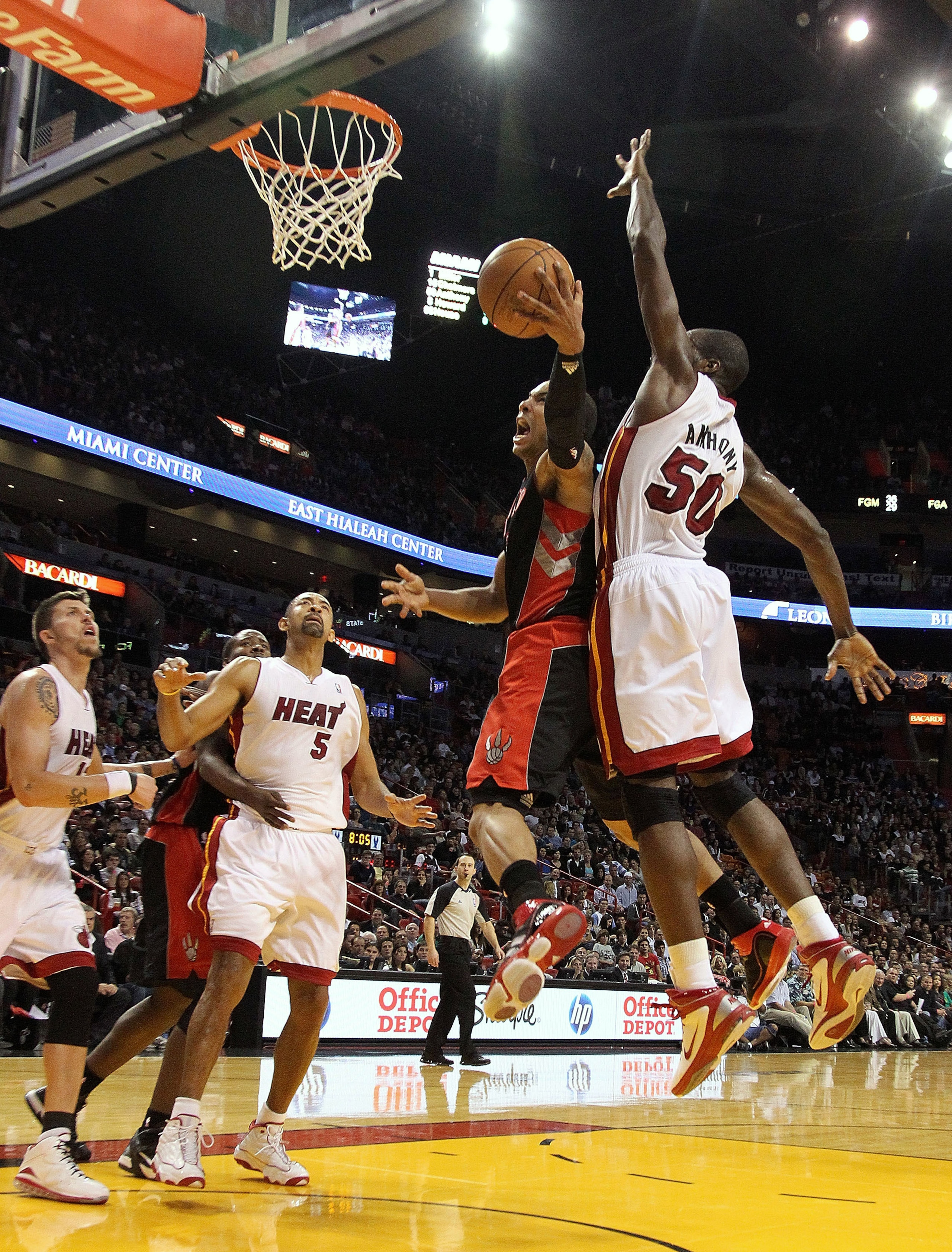 MIAMI, FL - JANUARY 22:  Jerryd Bayless #5 of the Toronto Raptors goes up for a shot against Joel Anthony #50 of the Miami Heat during a game at American Airlines Arena on January 22, 2011 in Miami, Florida. NOTE TO USER: User expressly acknowledges and a