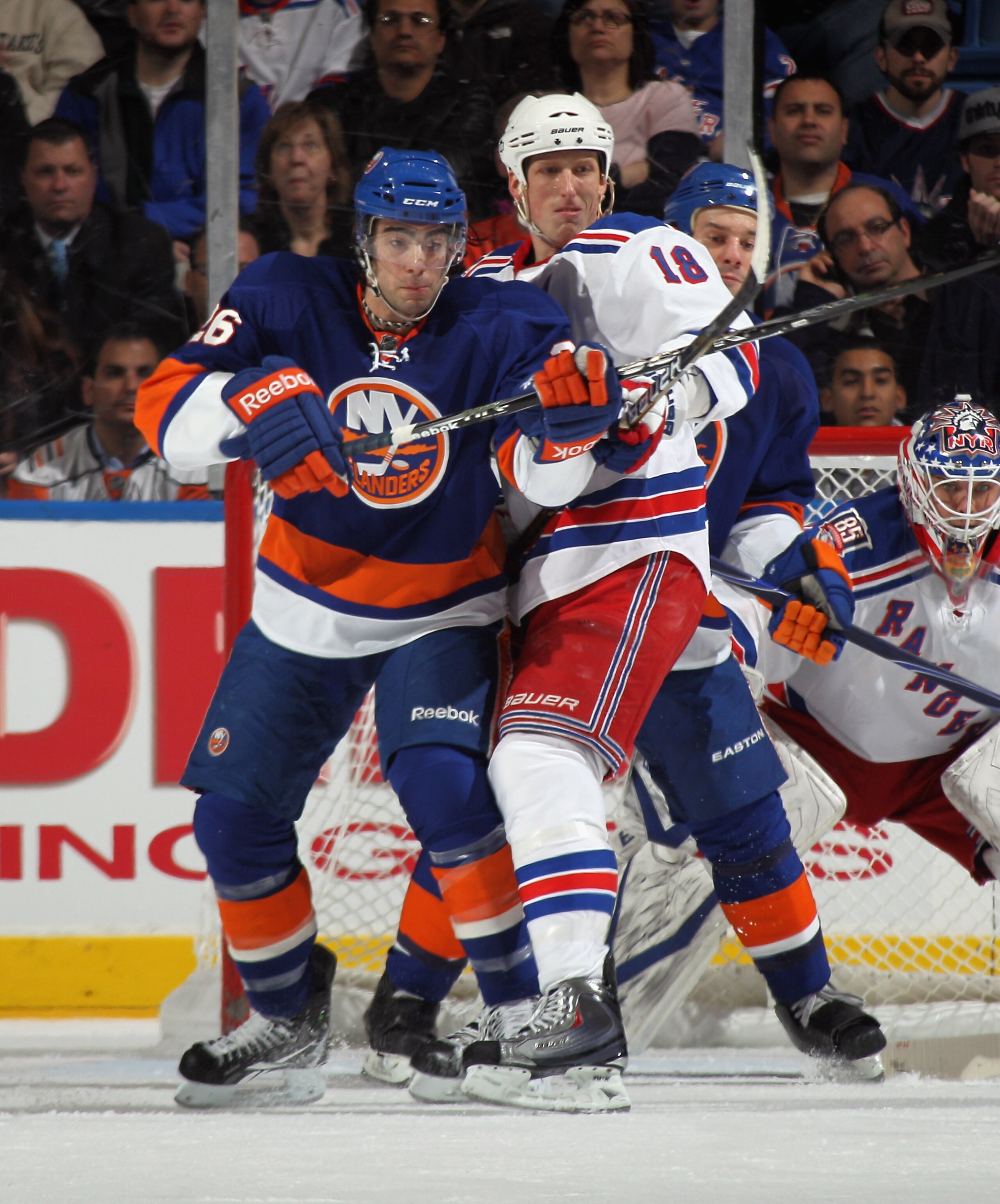 UNIONDALE, NY - DECEMBER 02: Matt Moulson #26 of the New York Islanders skates against Marc Staal #18 of the New York Rangers at the Nassau Coliseum on December 2, 2010 in Uniondale, New York.  (Photo by Bruce Bennett/Getty Images)