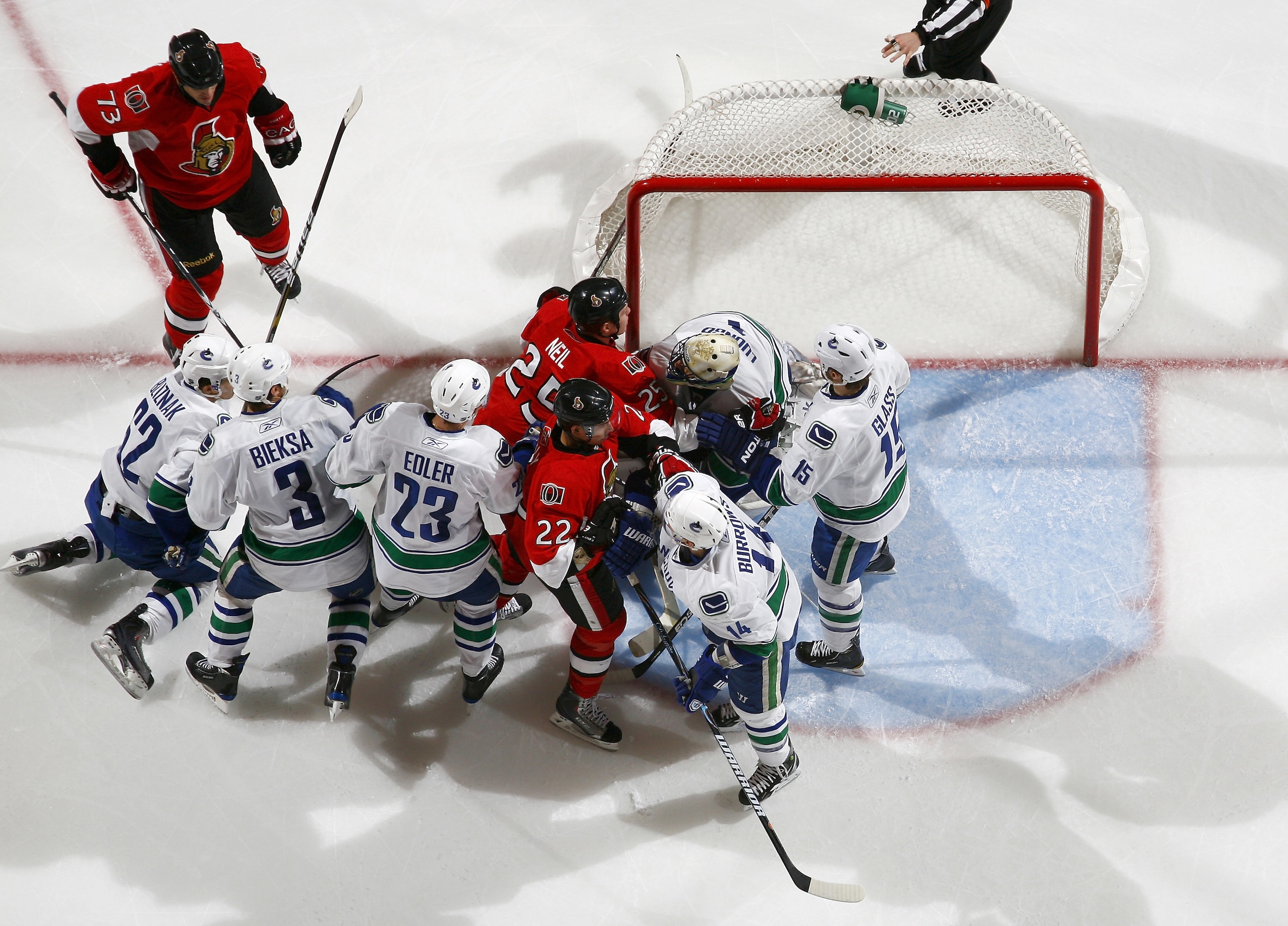 OTTAWA, CANADA - NOVEMBER 11:  Jarkko Ruutu #73;Chris Neil #25 and Chris Kelly #22 of the Ottawa Senators get into a scrum with Mario Bliznak #62;Kevin Bieksa #3;Alexander Edler #23;Alexandre Burrows #14;Roberto Luongo #1 and Tanner Glass #15 of the Vanco