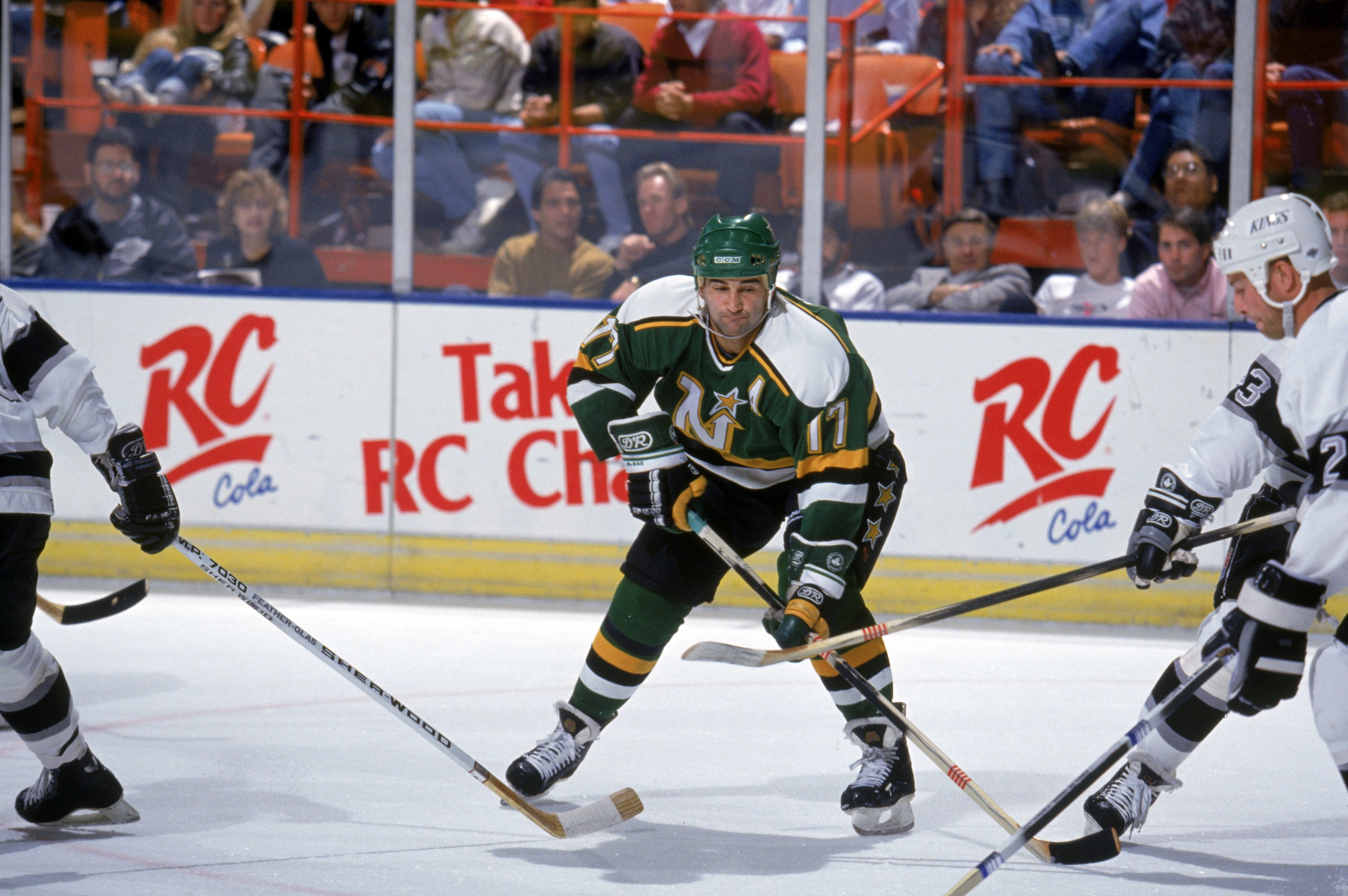 INGLEWOOD, CA - 1990:  Basil McRae #17 of the Minnesota North Stars battles for the puck during a game against the Los Angeles Kings in the 1990-1991 NHL season at the Great Western Forum in Inglewood, California.  (Photo by Rick Stewart/Getty Images)