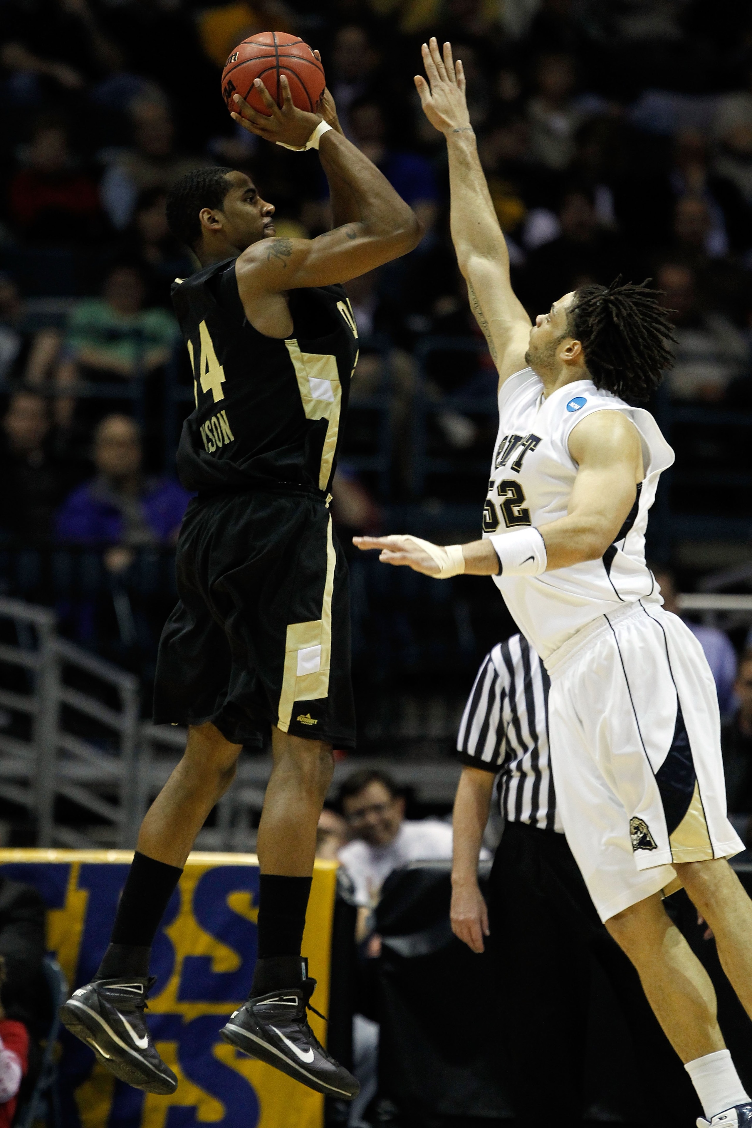 MILWAUKEE - MARCH 19: Keith Benson #34 of the Oakland Golden Grizzlies shoots the ball over Gary McGhee #52 of the Pittsburgh Panthers in the second half during the first round of the 2010 NCAA men's basketball tournament at the Bradley Center on March 1 MILWAUKEE - MARCH 19: Keith Benson #34 of the Oakland Golden Grizzlies shoots the ball over Gary McGhee #52 of the Pittsburgh Panthers in the second half during the first round of the 2010 NCAA men's basketball tournament at the Bradley Center on March 1