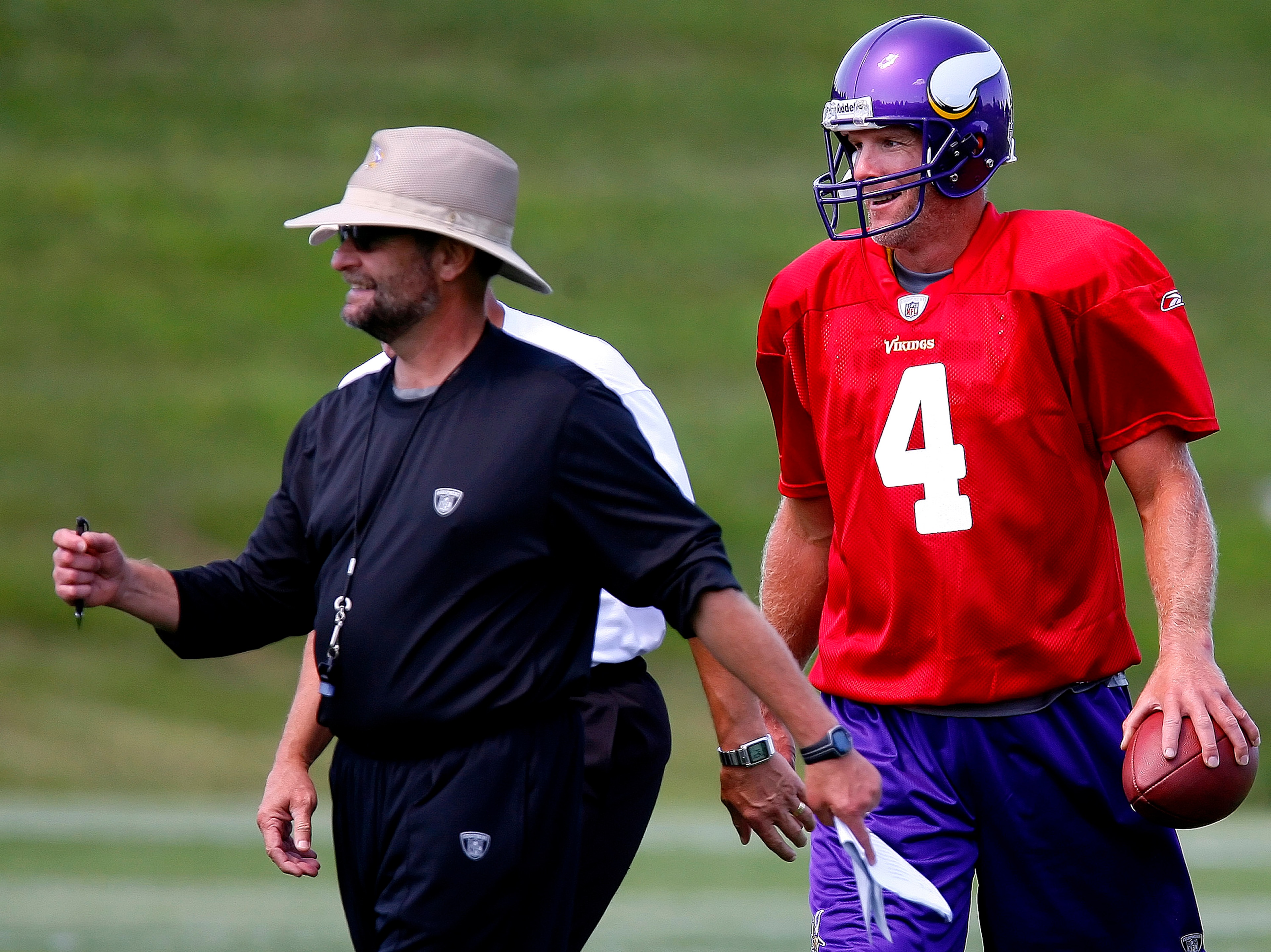 EDEN PRAIRIE, MN - AUGUST 18:  Minnesota Vikings Head Coach Brad Childress (L) walks with Brett Favre #4 after finishing  a passing drill during a Minnesota Vikings practice session on August 18, 2009 at Winter Park in Eden Prairie, Minnesota. Favre has r